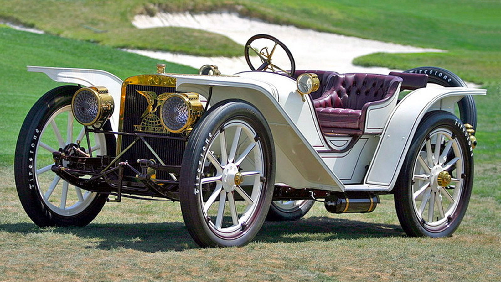 A white American Model 50 Roadster parked at a golf course 