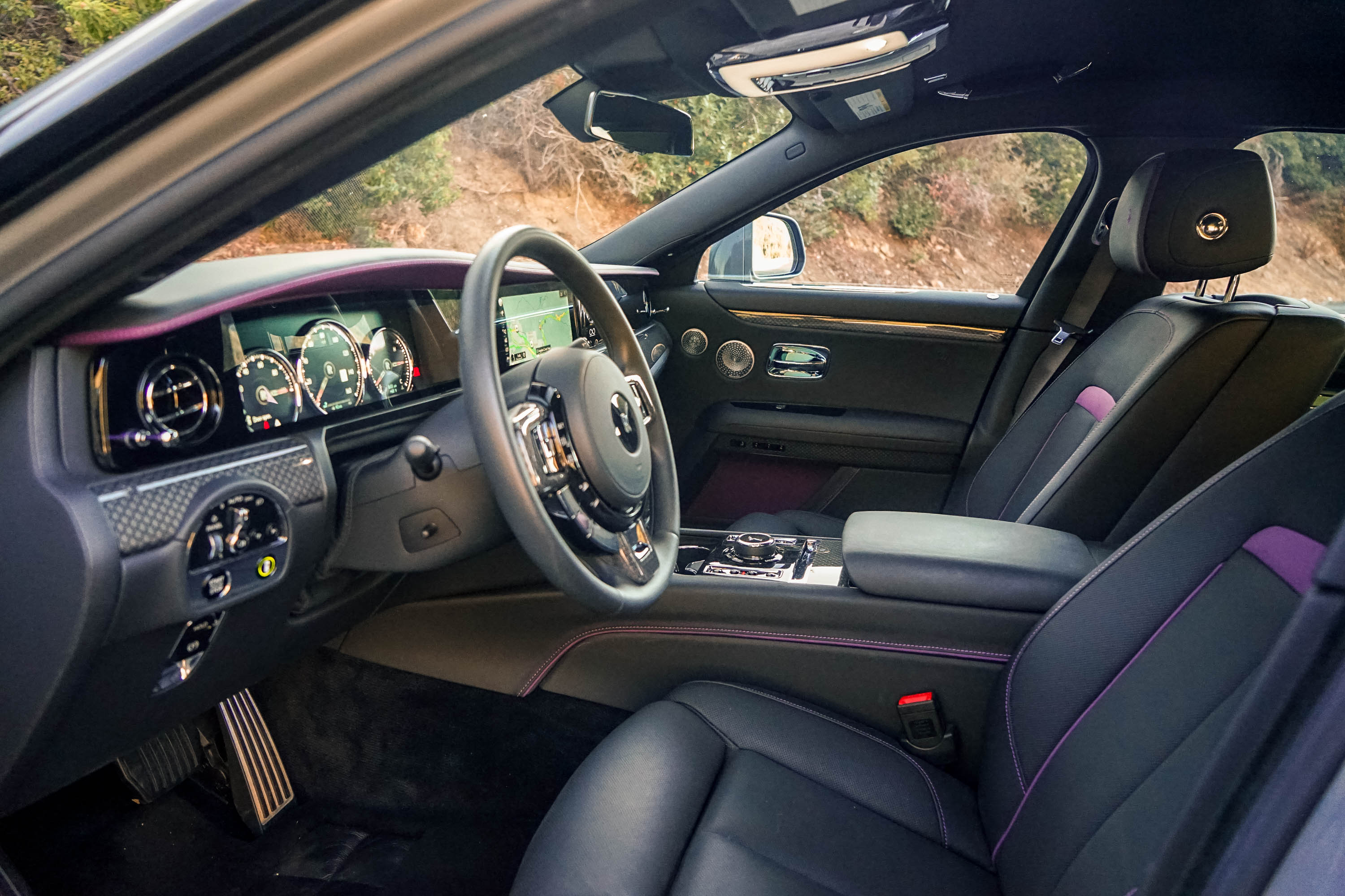 The interior of the 2023 Rolls-Royce Black Badge Ghost interior in black, purple and carbon