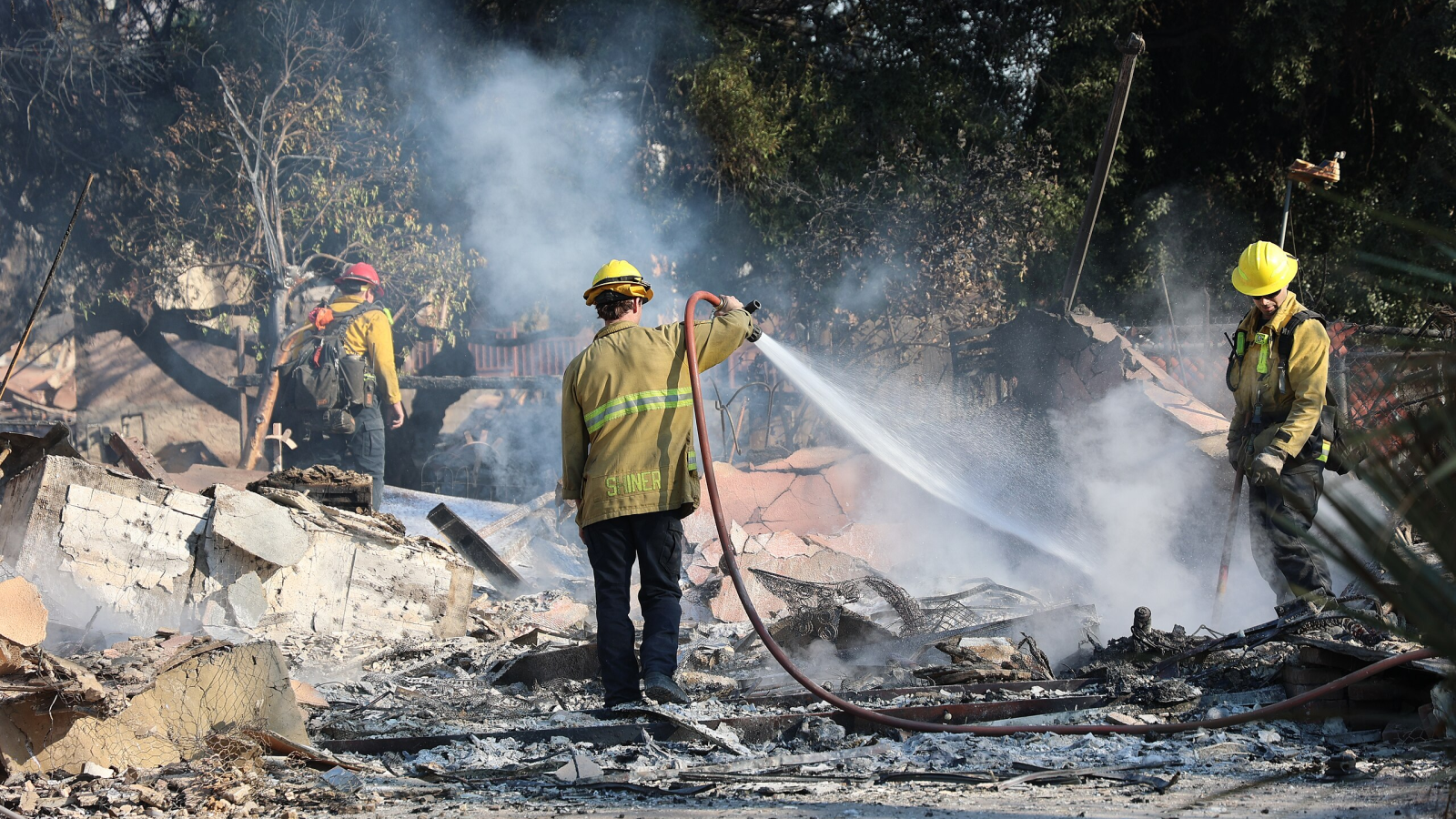 A photo of firefighters spraying water in Los Angeles. 