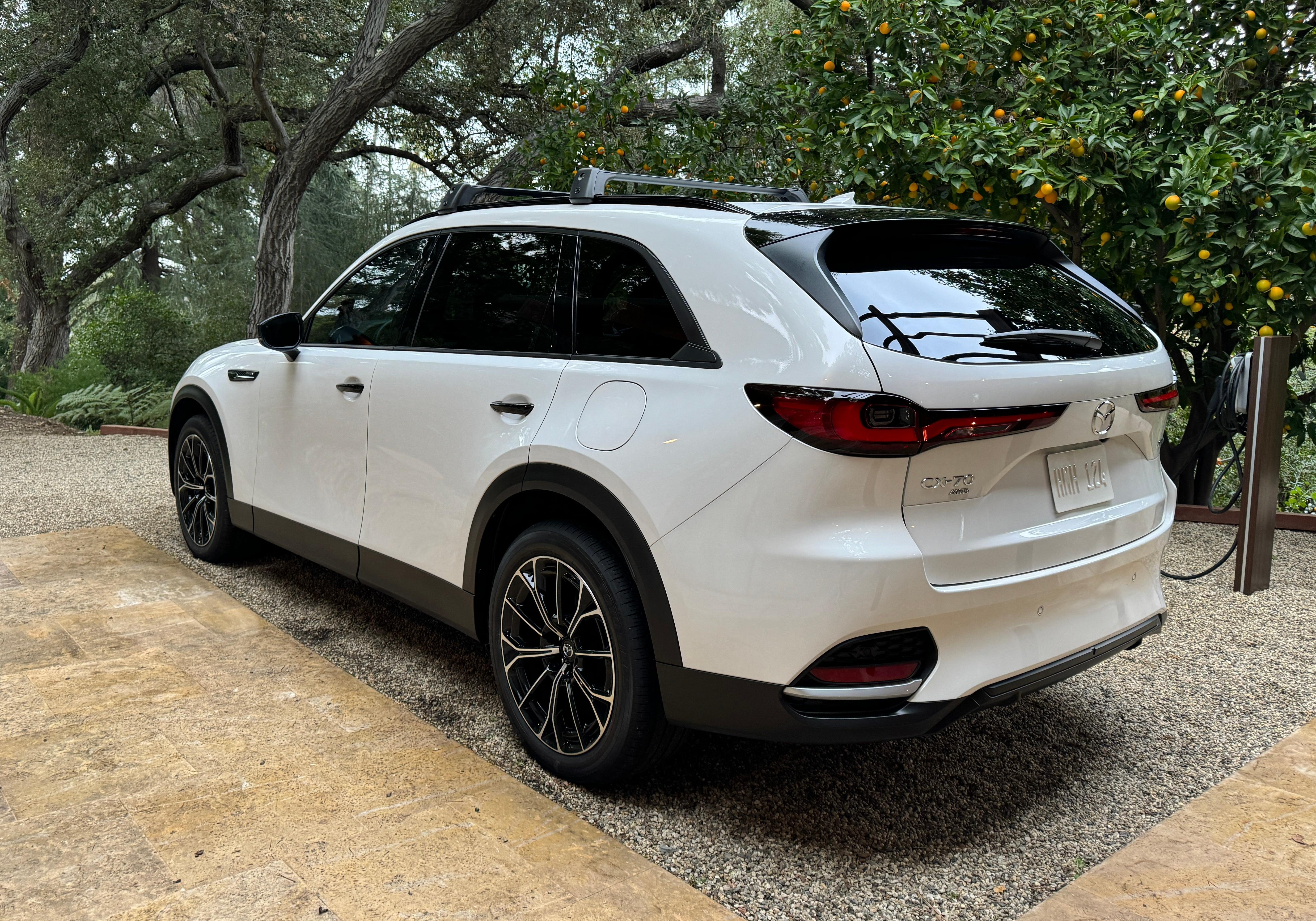 Rear 3/4 view of a white 2025 Mazda CX-70