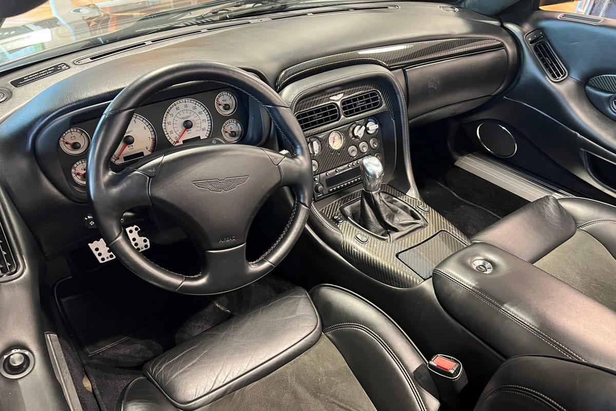 A shot of the interior of the car showing off the charcoal leather and alcantara and the solid metal shifter