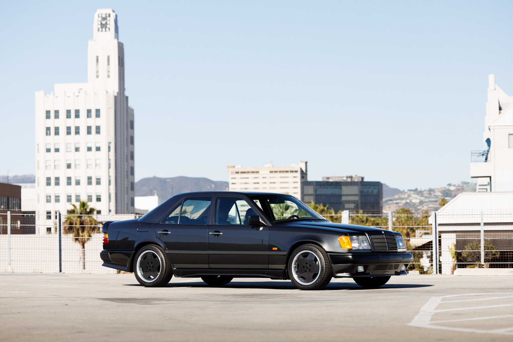 Front 3/4 view of a black Mercedes-Benz AMG 300E 6.0 Hammer