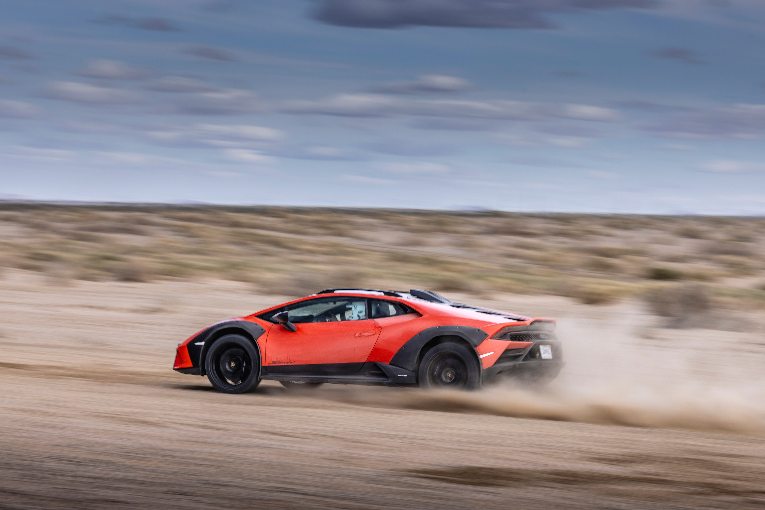 Side view of the 2024 Lamborghini Huracan Sterrato driving in the desert