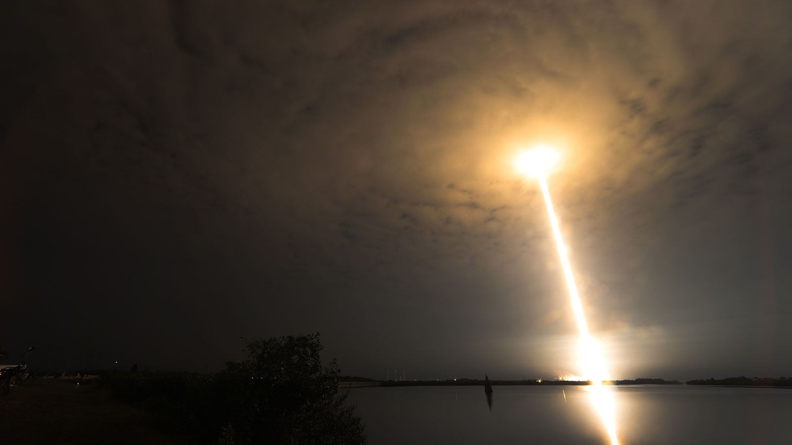 A long exposure photo showing the stream of light left by a SpaceX rocket at takeoff. 