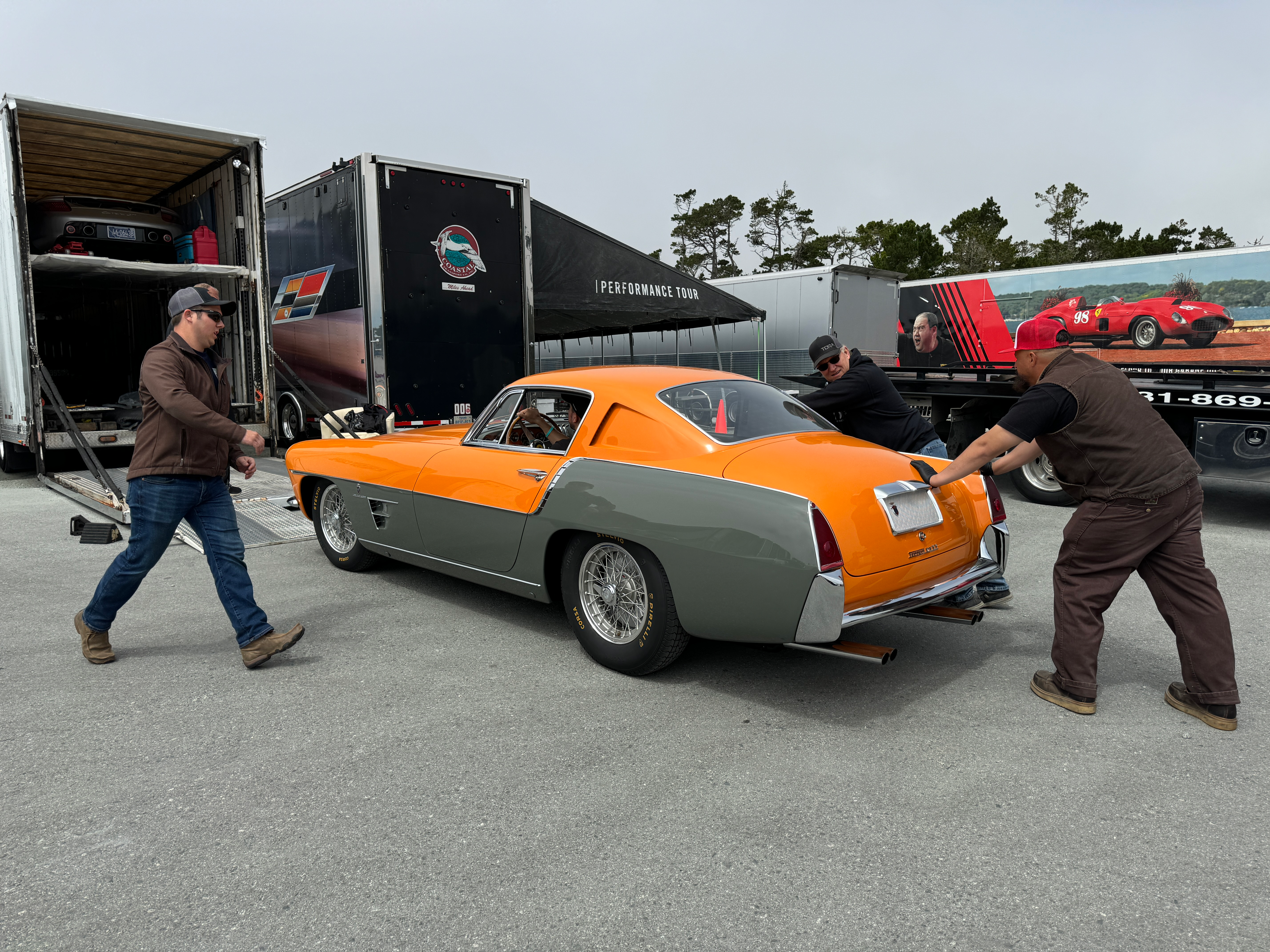 Rear 3/4 view of an orange and grey 1954 Ferrari 375 MM Ghia Coupe