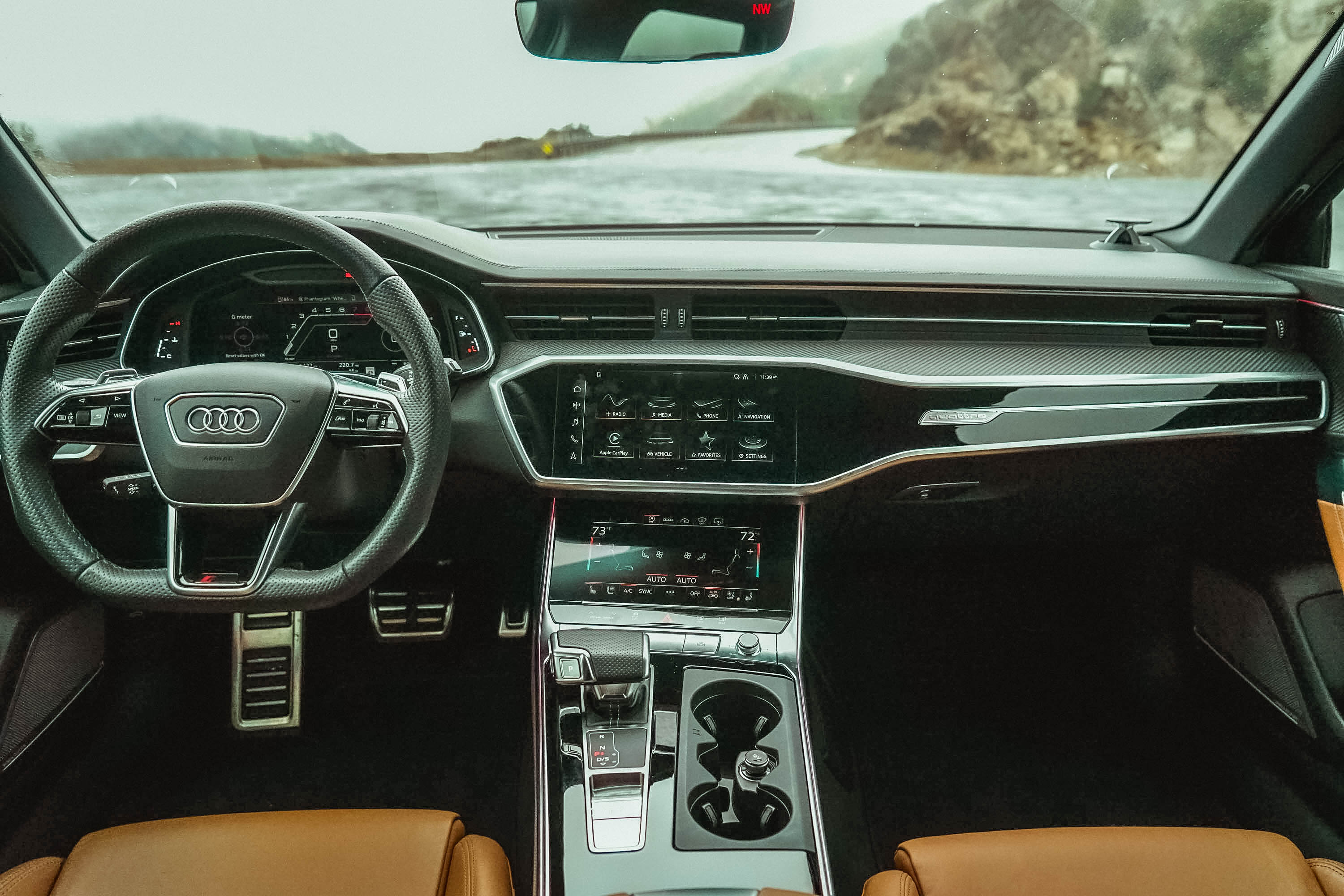 The interior of the 2022 Audi RS 6 Avant with brown leather seats and carbon fiber dash inserts