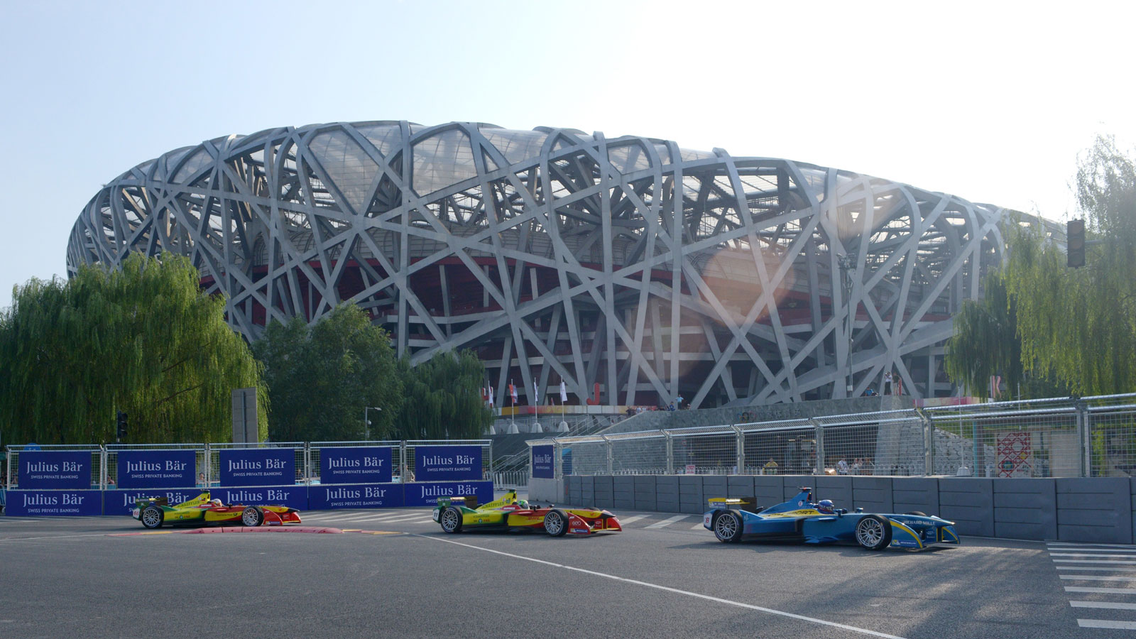 A photo of Formula E cars racing past the Birdsnest Stadium in Beijing during the first race. 