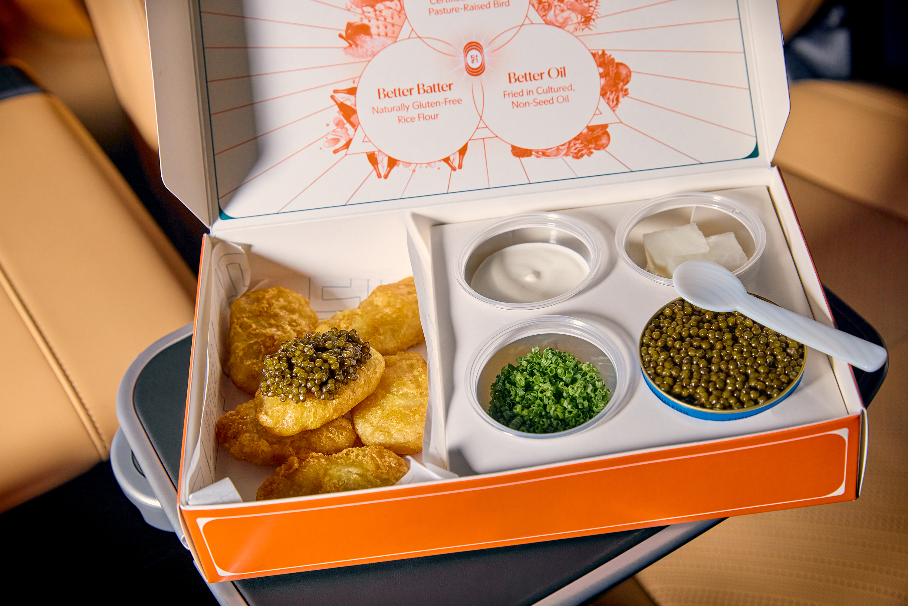 A box of takeout chicken nuggets and caviar