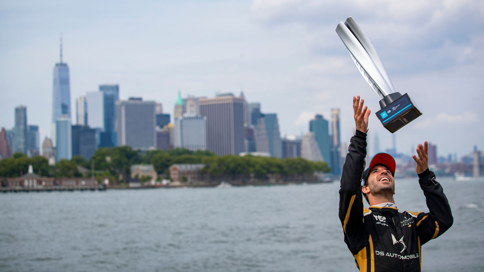 A photo of Antonio Felix da Costa throwing his New York trophy into the air. 