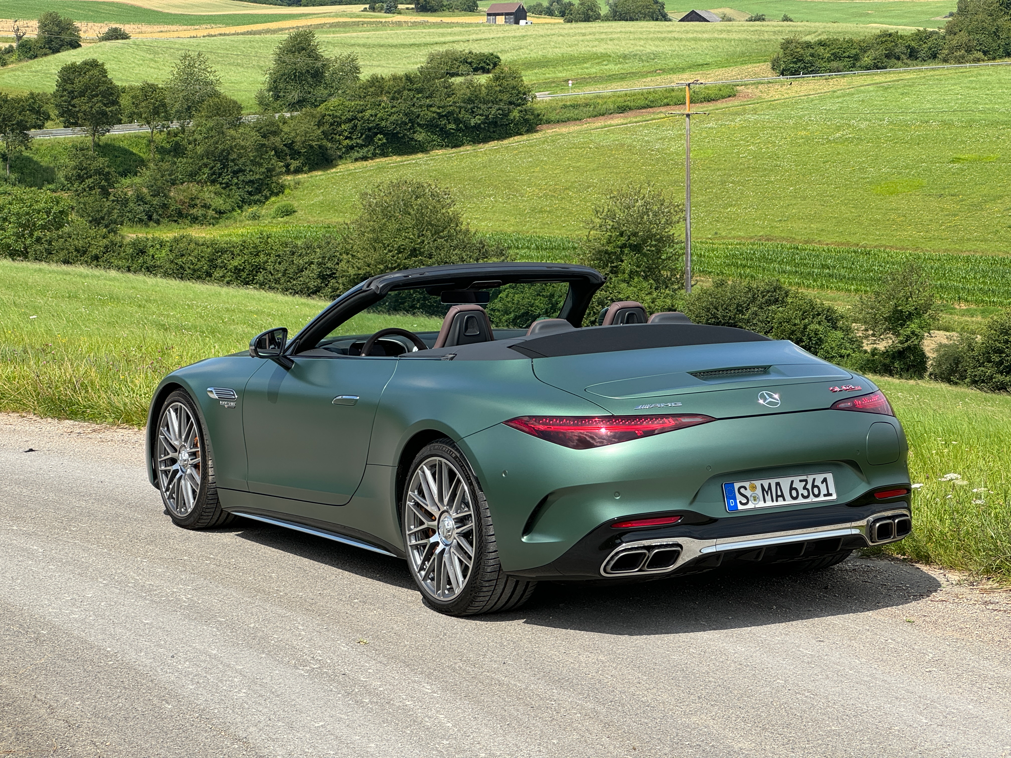 Rear 3/4 view of a matte green Mercedes-AMG SL63 S E Performance