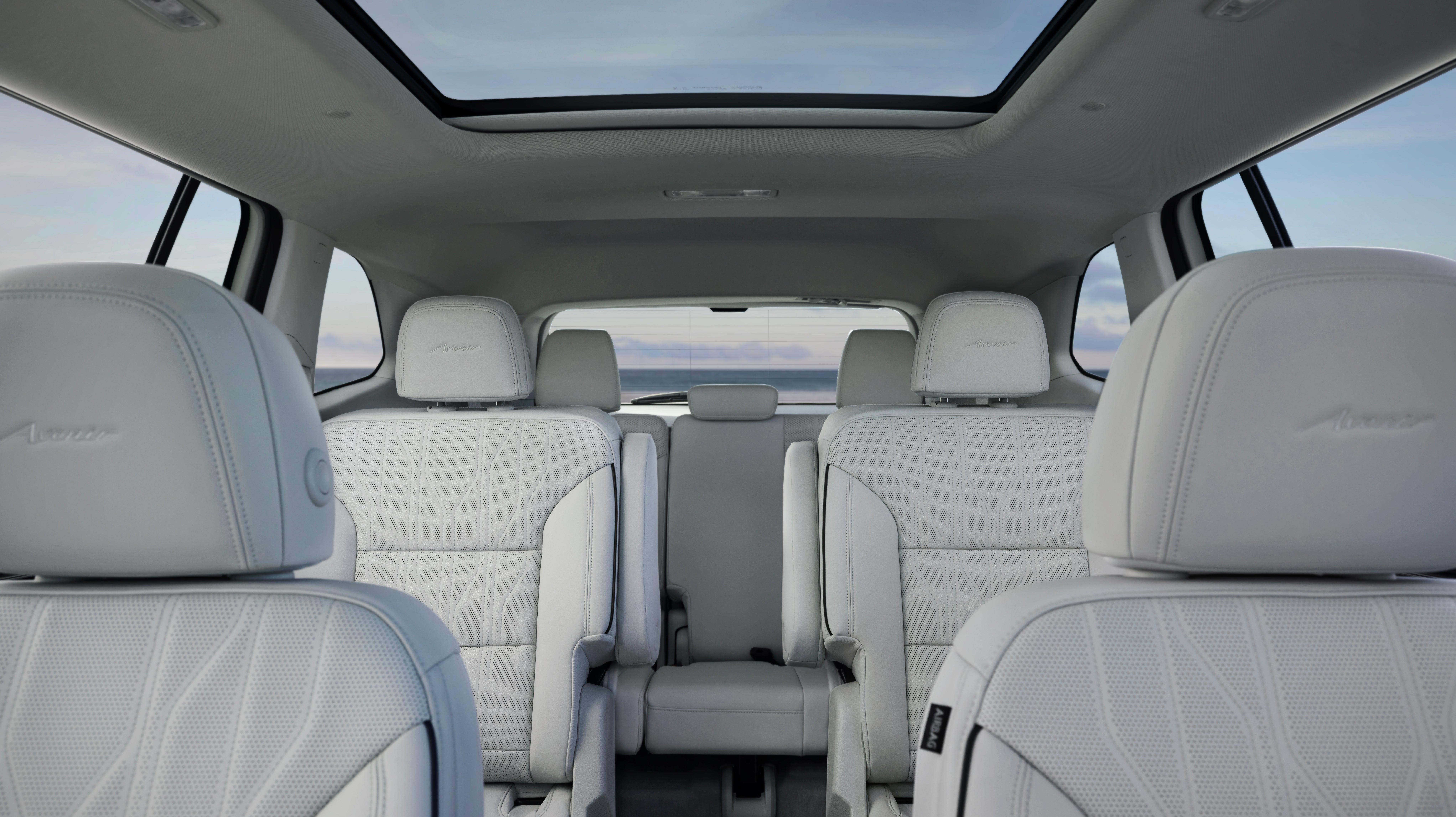 A shot of the interior of the Buick Enclave Avenir, looking past the front row out the rear of the vehicle.