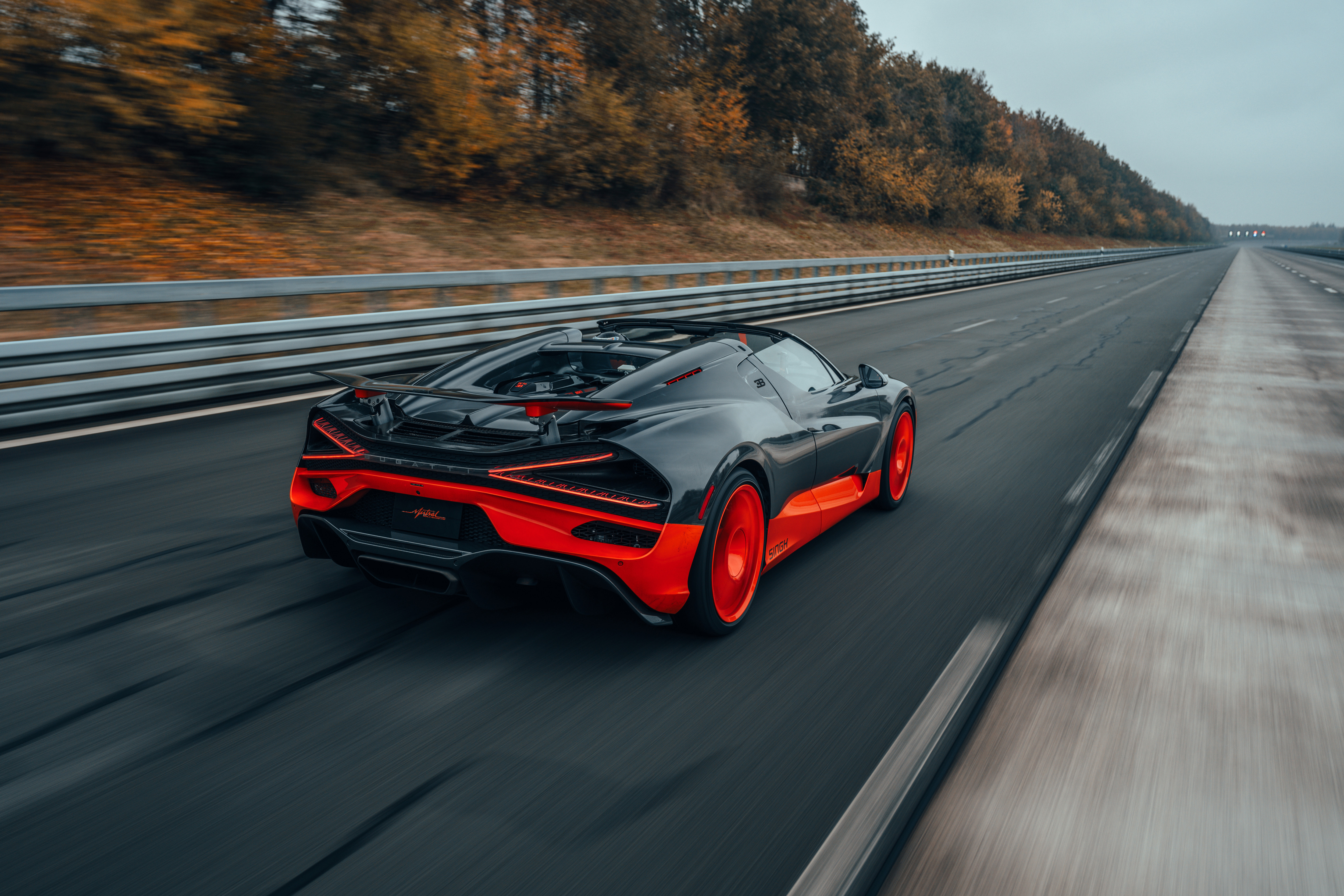 Rear 3/4 view of the black and orange Bugatti W16 Mistral World Record Car