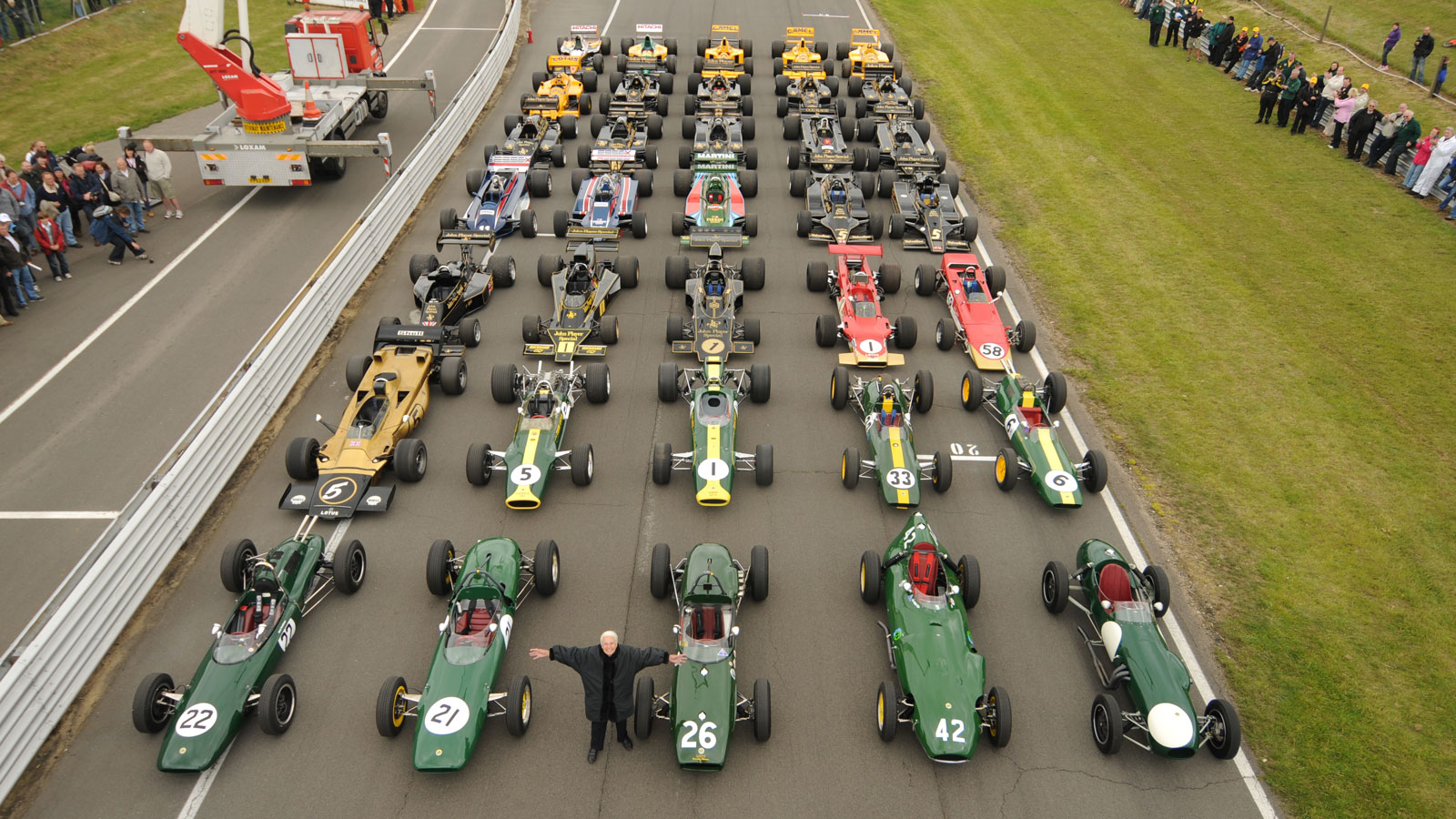 Helen Chapman stood in front of historic Lotus race cars 