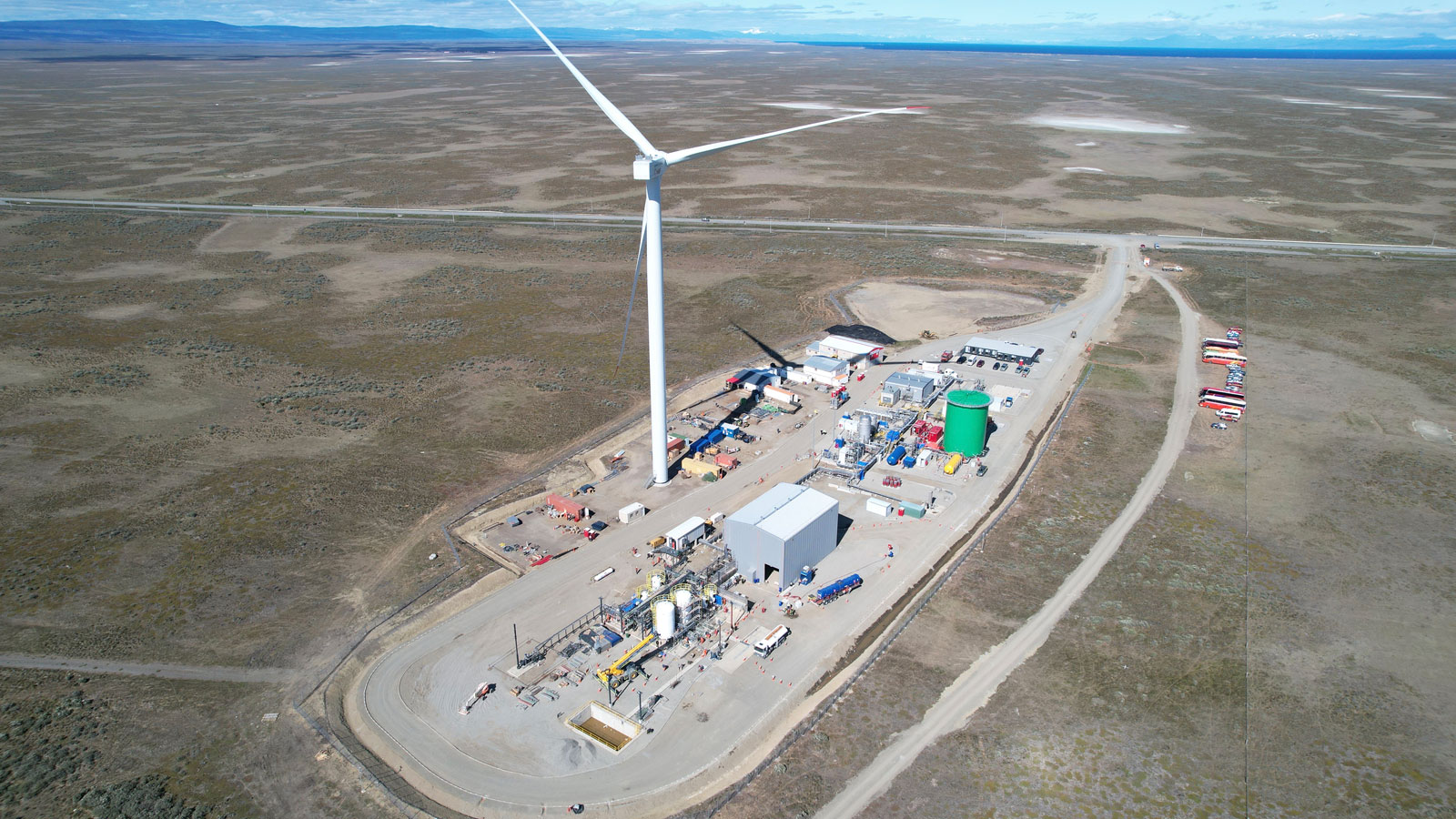 A photo of a synthetic fuel plant in Chile with a large wind turbine. 