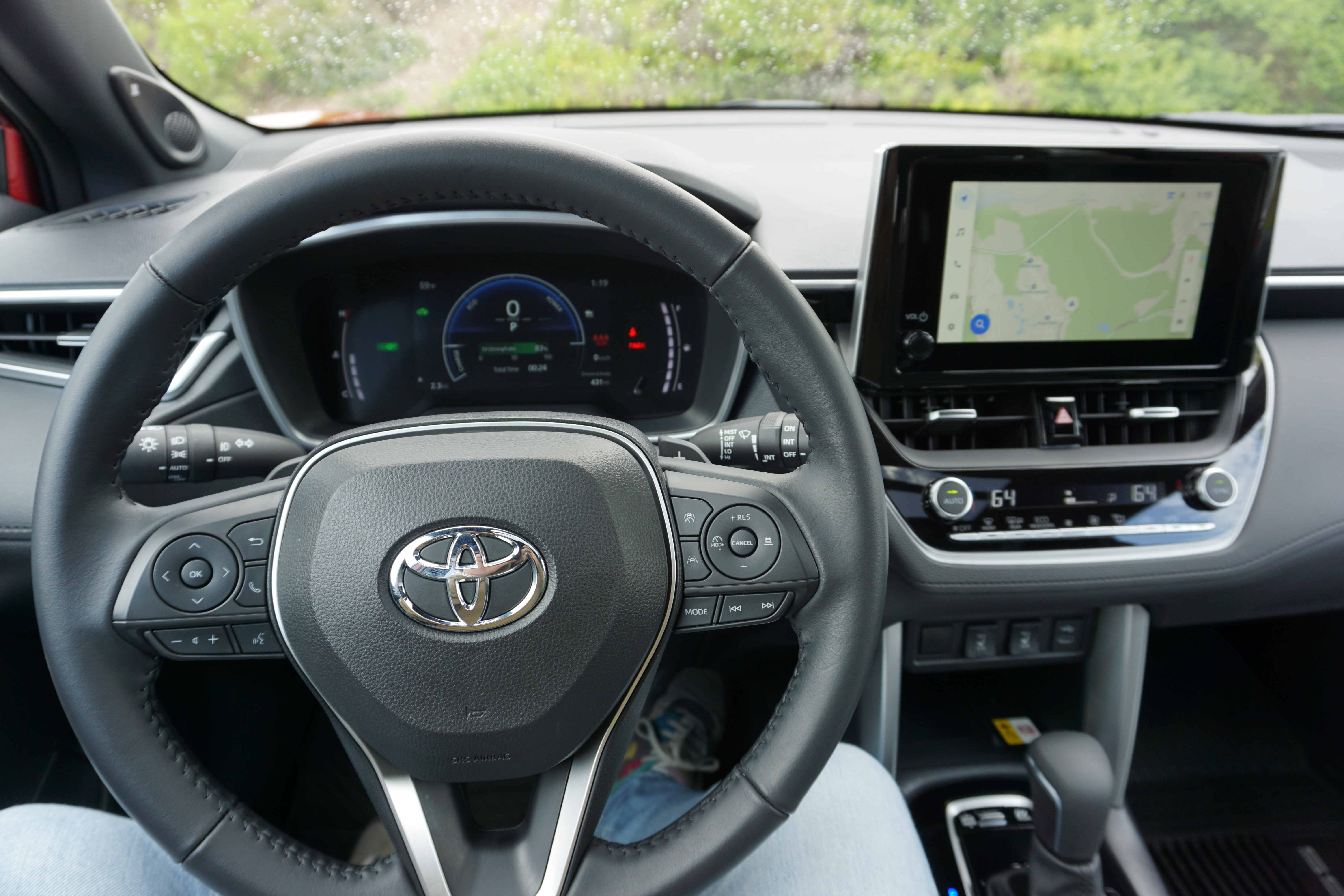 A red 2023 Toyota Corolla Cross Hybrid.