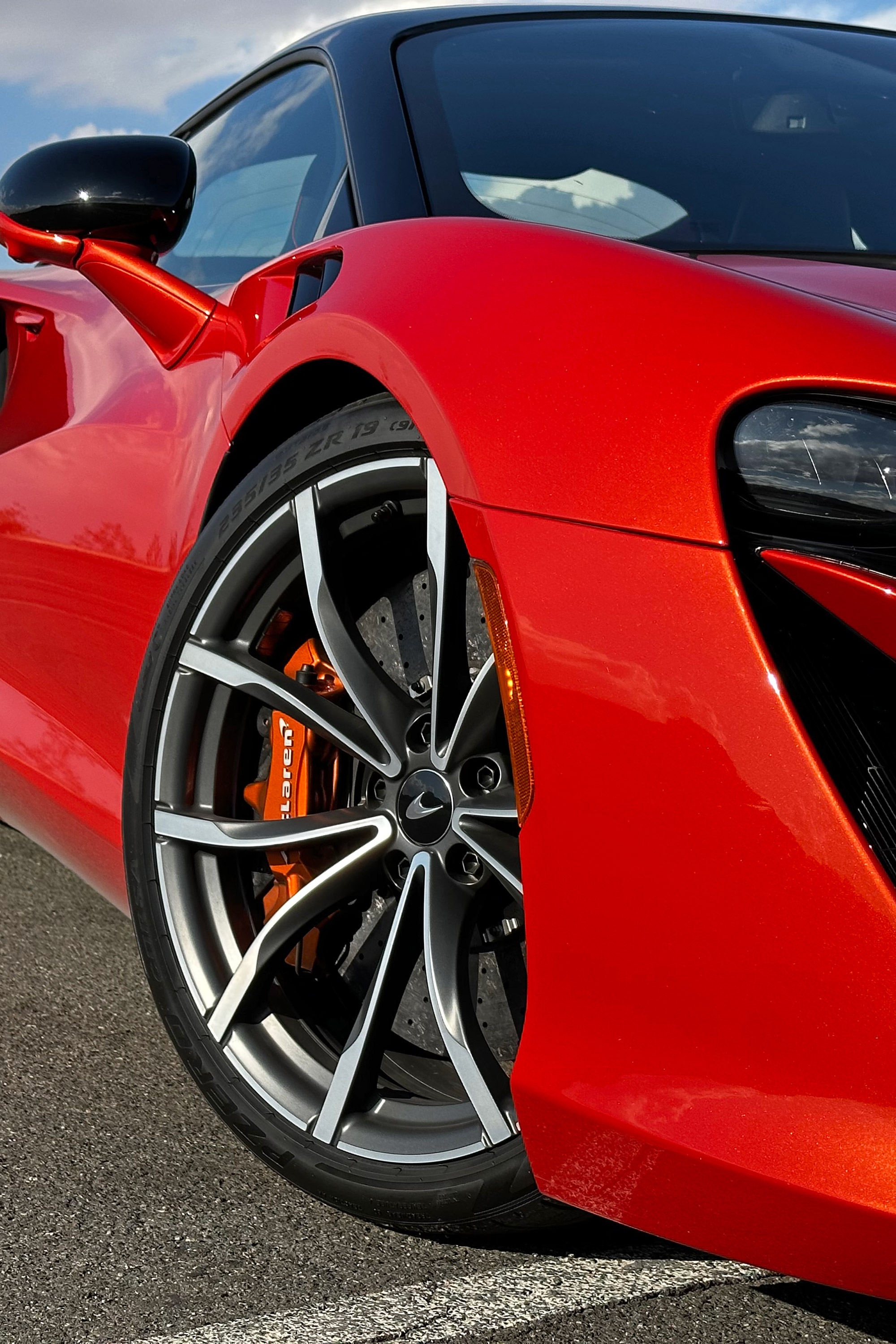 Close-up on the passenger-side front wheel of the 2023 McLaren Artura in Burnt Orange.