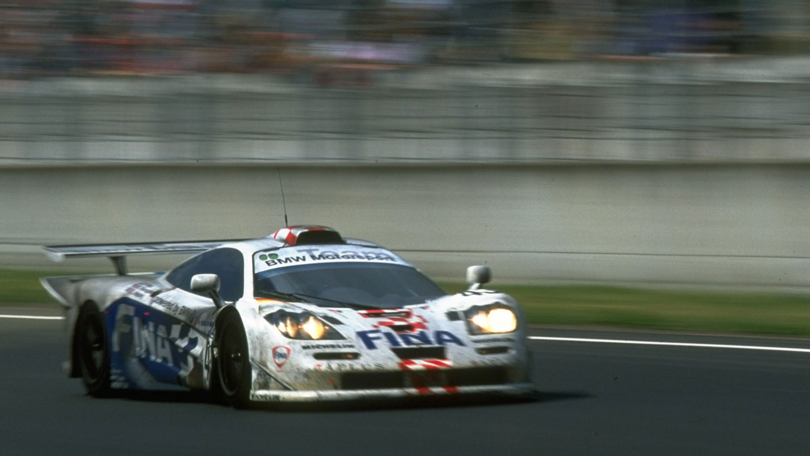 A photo of a red, white and blue, BMW-branded McLaren F1 race car. 