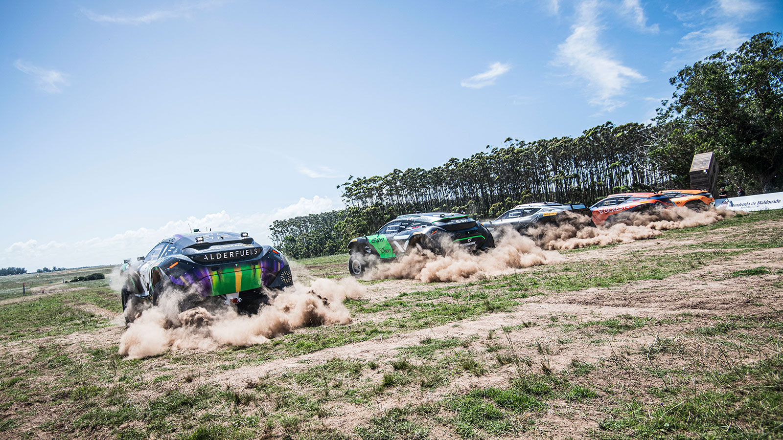 A photo of five Extreme E cars racing off the line. 