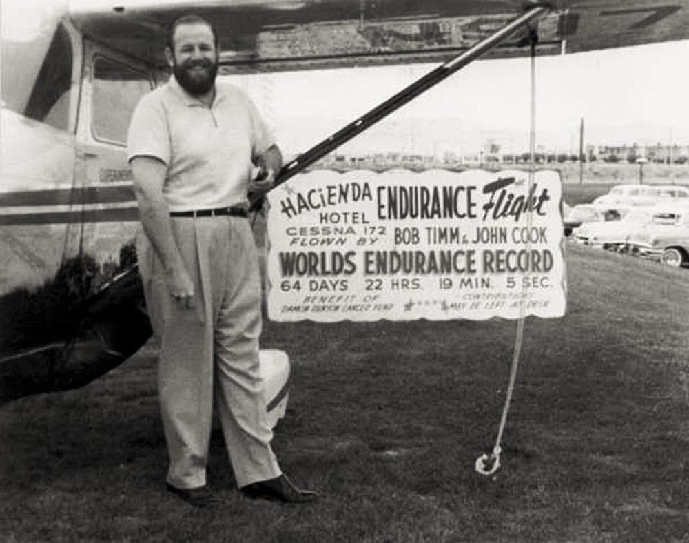 Robert Timm stands in front of a world record sign.