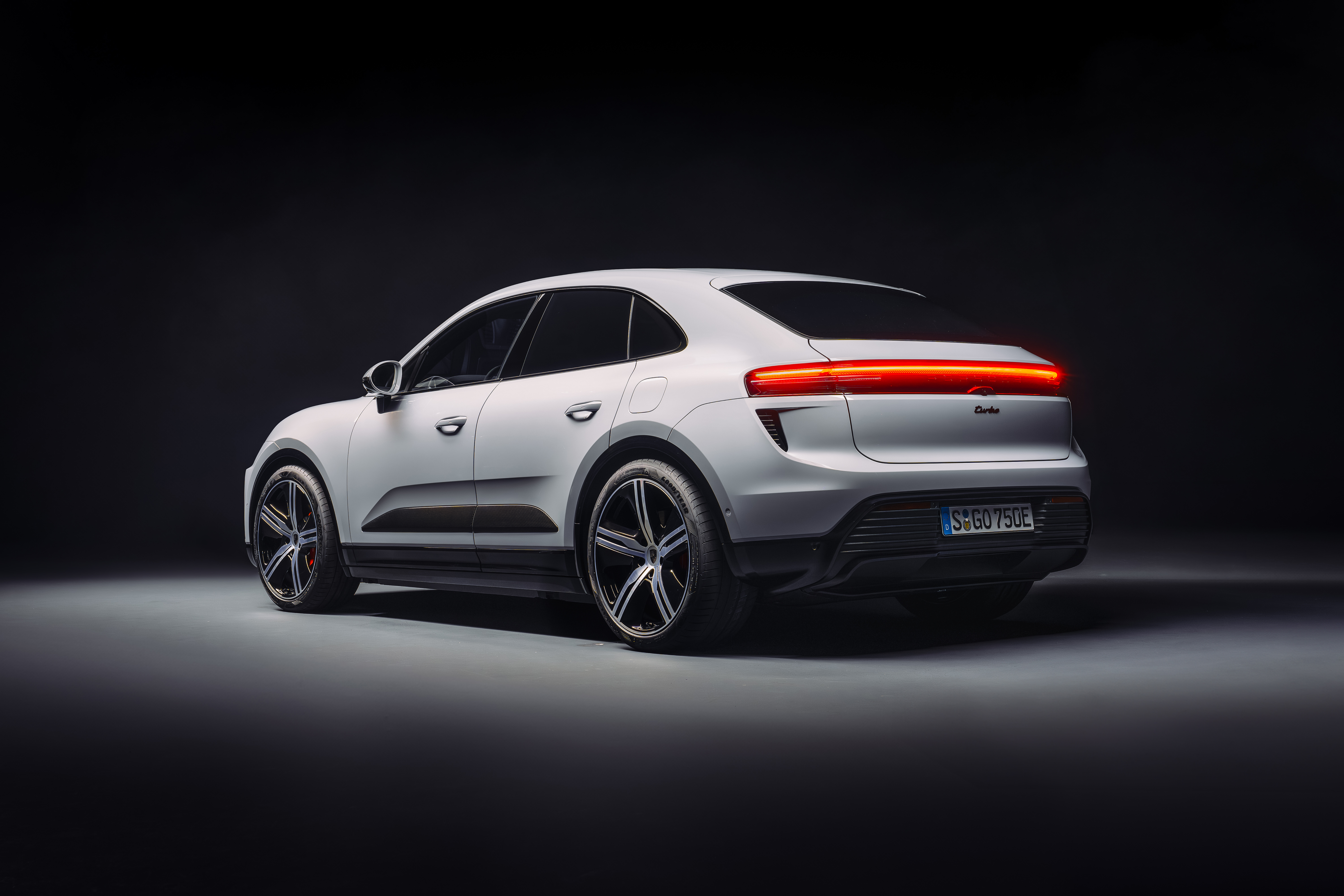 Rear 3/4 view of a white 2024 Porsche Macan EV