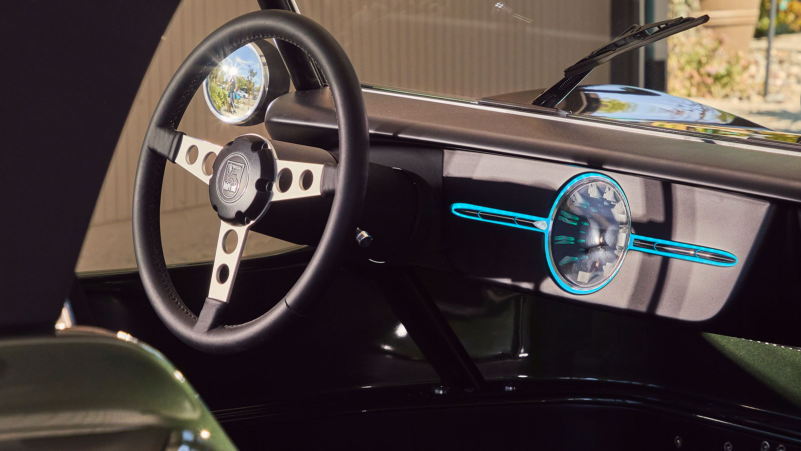 A photo of the Meyers Manx interior with blue light around the speedo. 