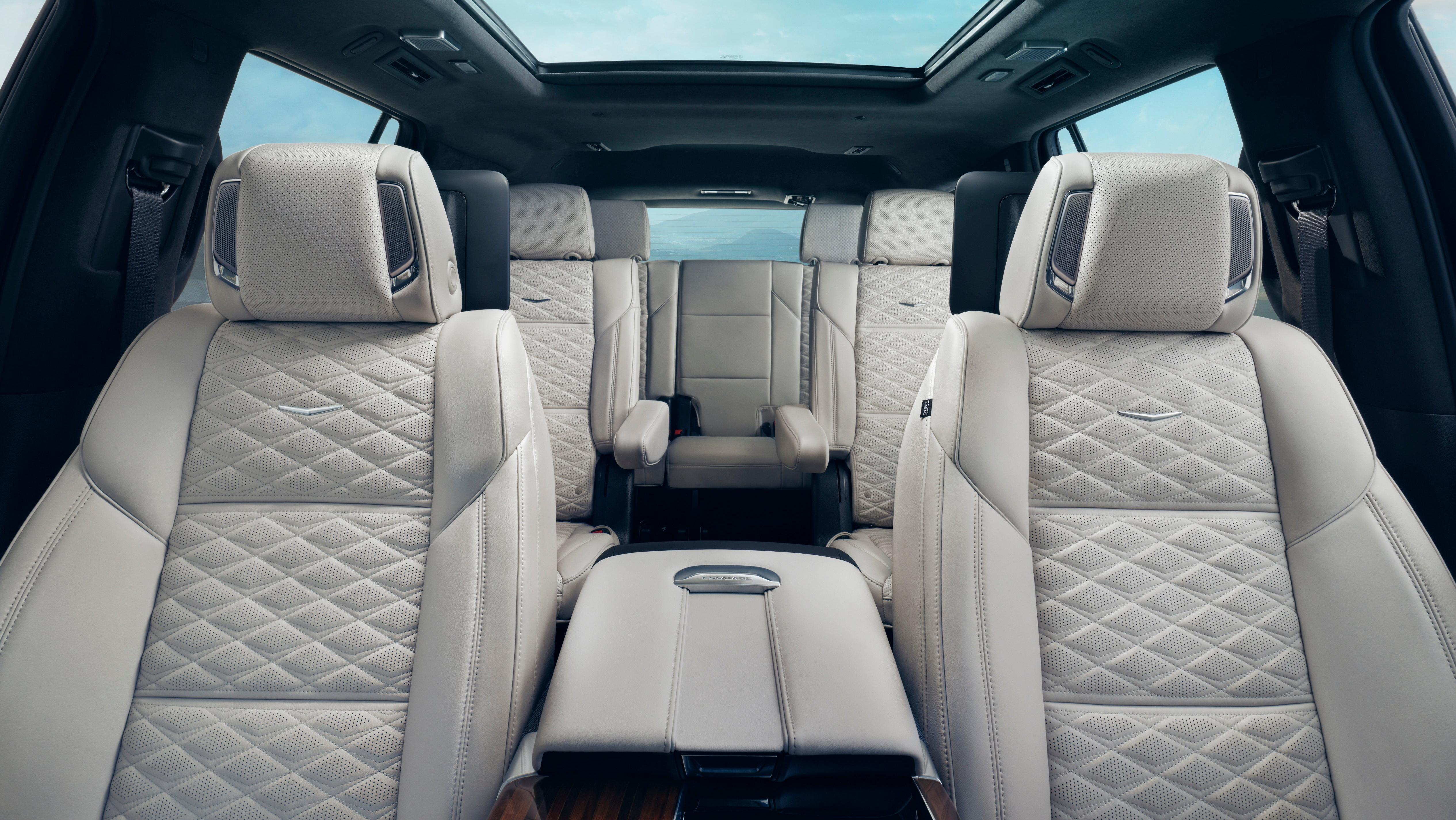 A photo looking back at all three rows of seats in the new Escalade with white leather 