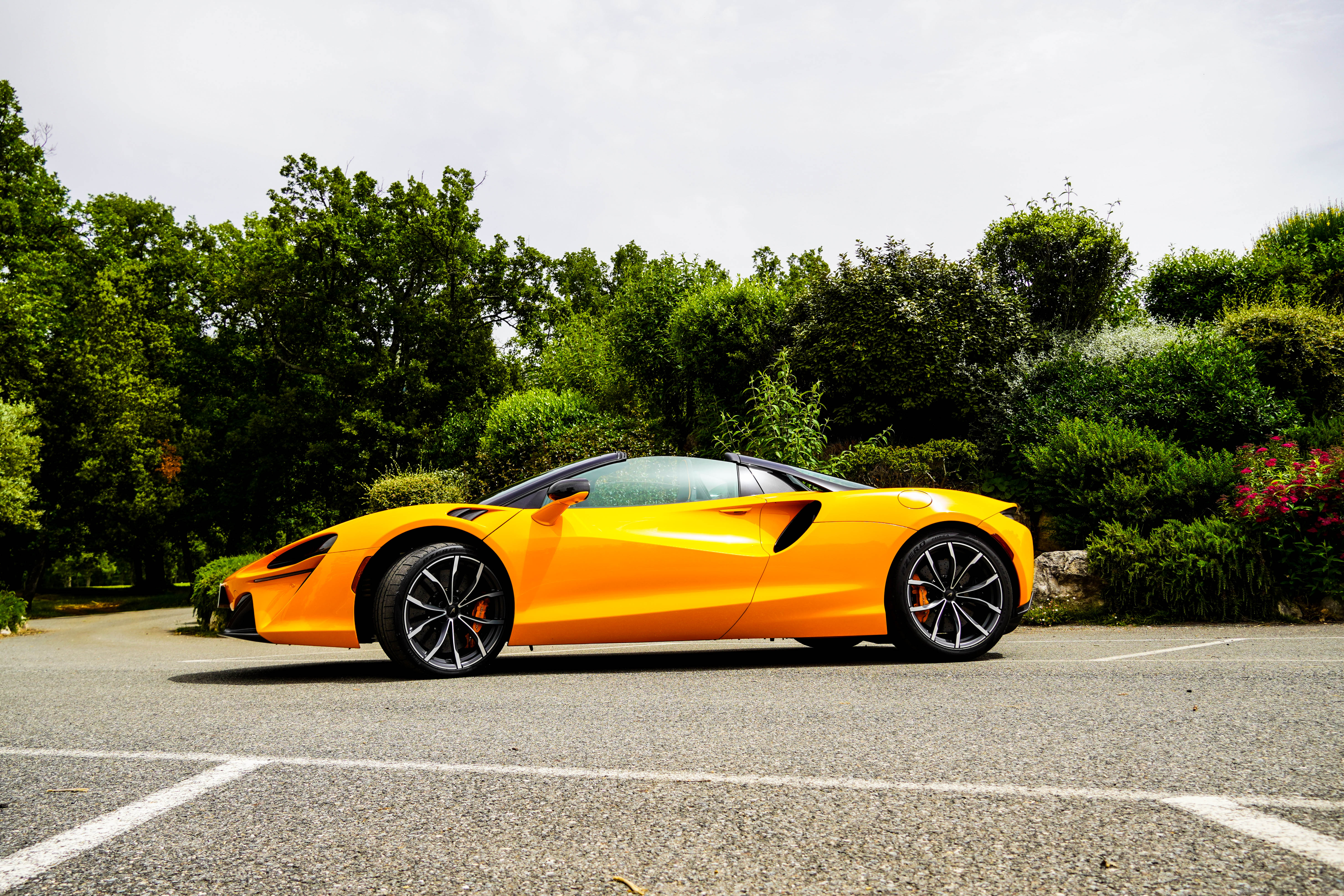 Side view of an orange McLaren Artura Spider