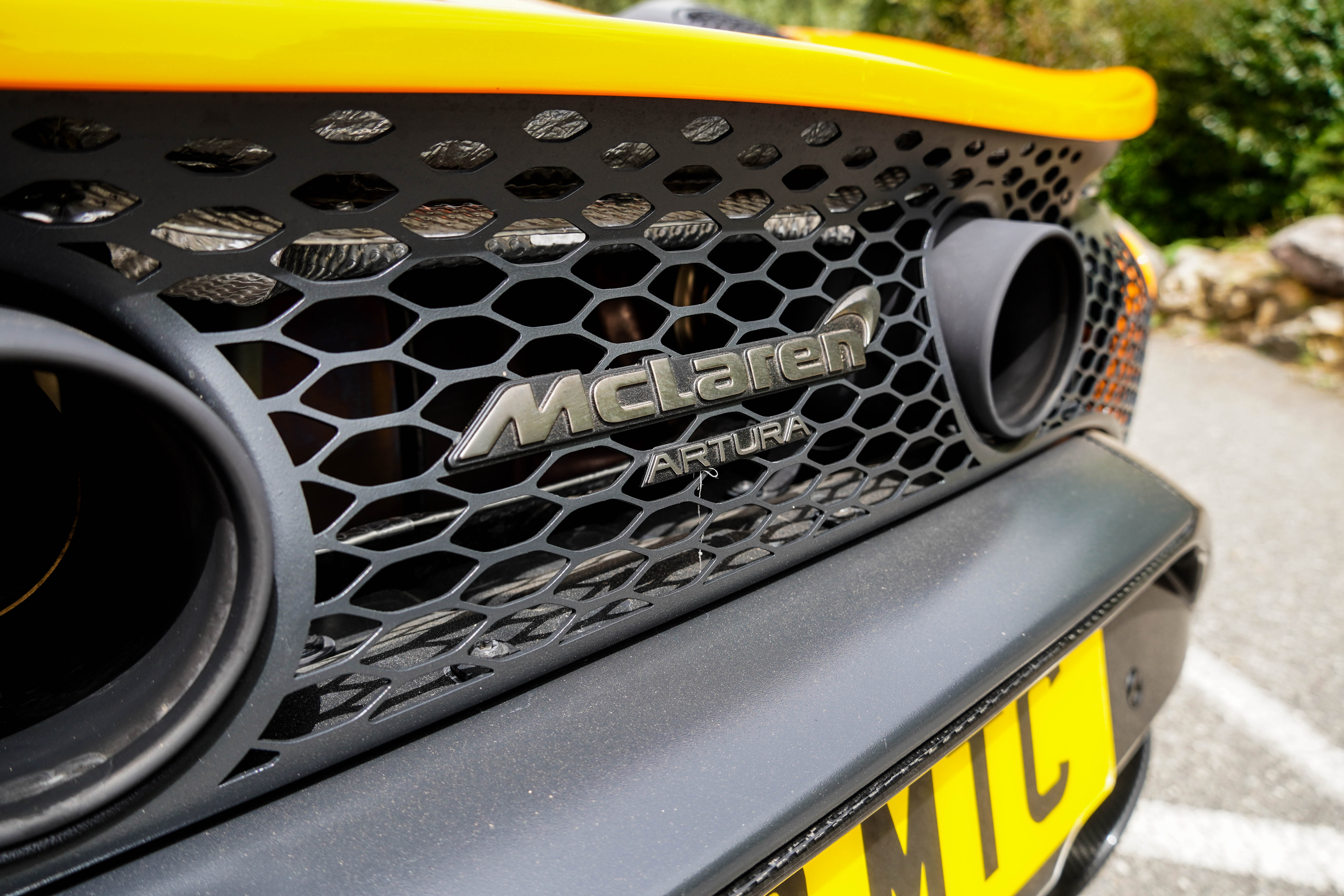 Rear badge of an orange McLaren Artura Spider