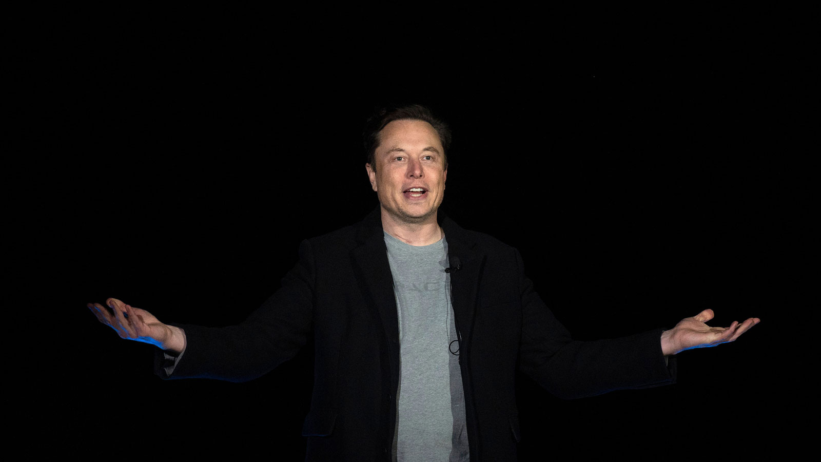 Elon Musk gestures as he speaks during a press conference at SpaceX's Starbase.