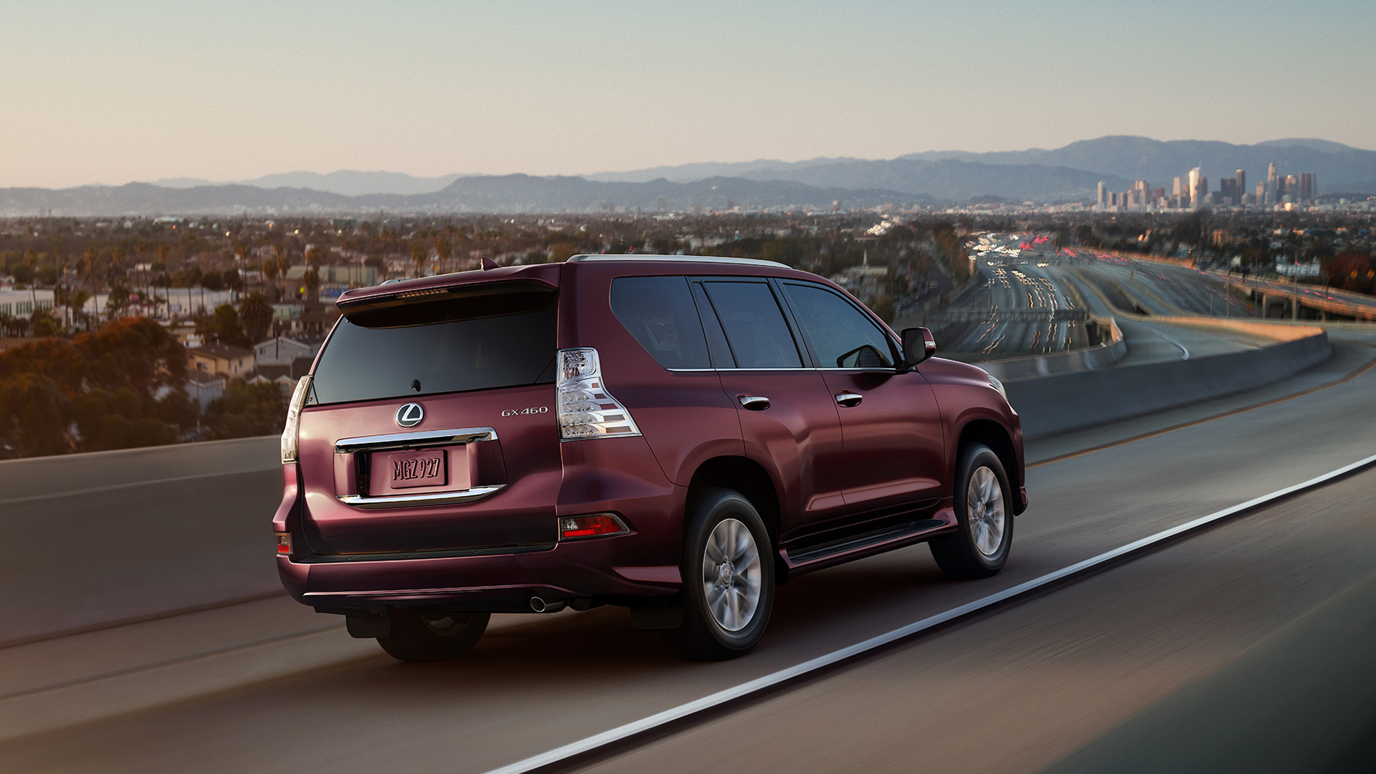 Burgundy 2021 Lexus GX rear three-quarter view driving on highway