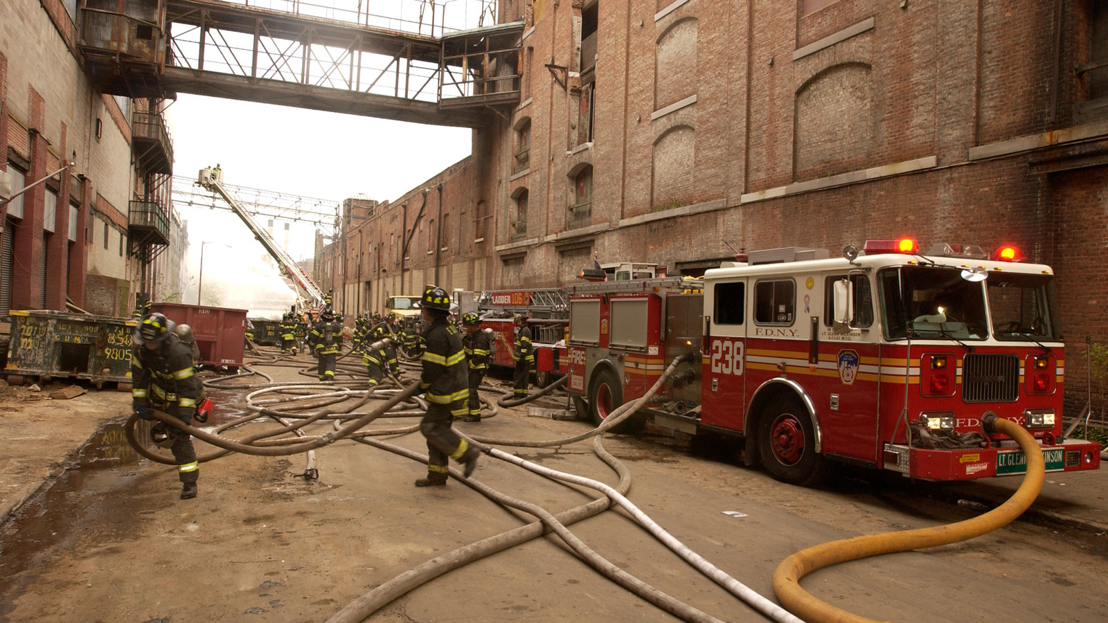 A photo of fire fighters in New York rushing from their engines. 