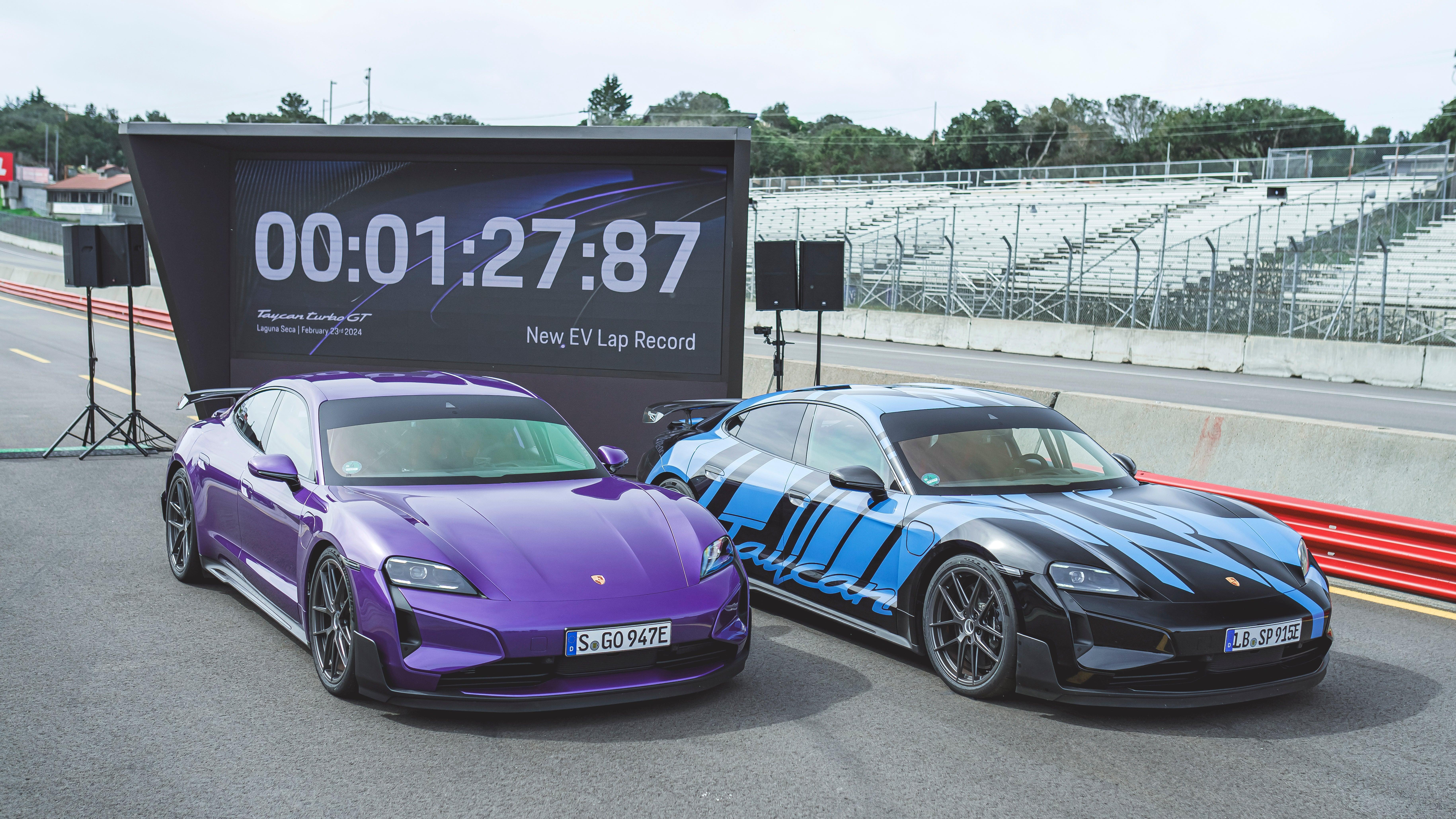 Two Porsche Taycan Turbo GTs parked next to each other on a racetrack