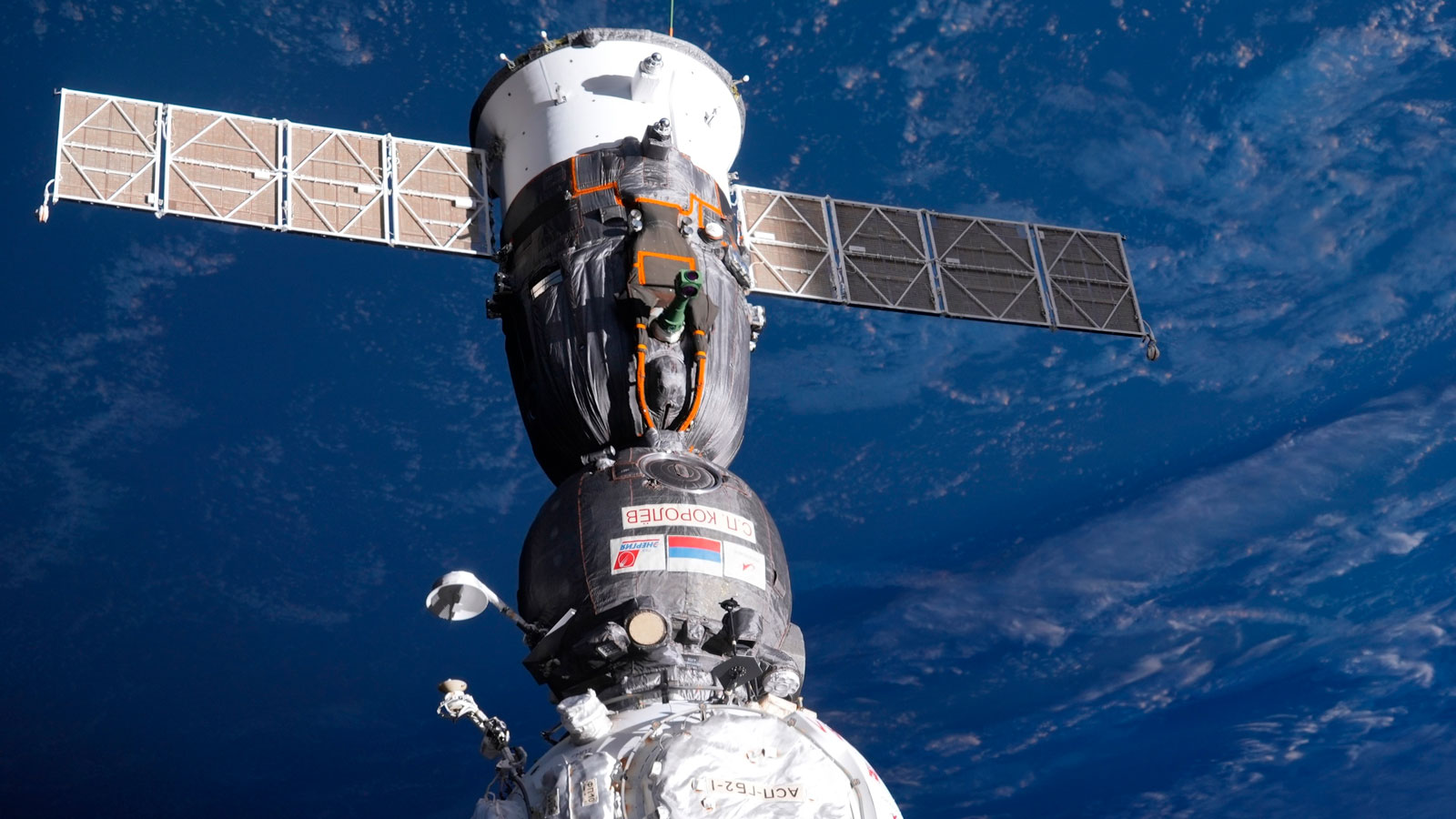 A photo of a Soyuz capsule docked with the International Space Station. 