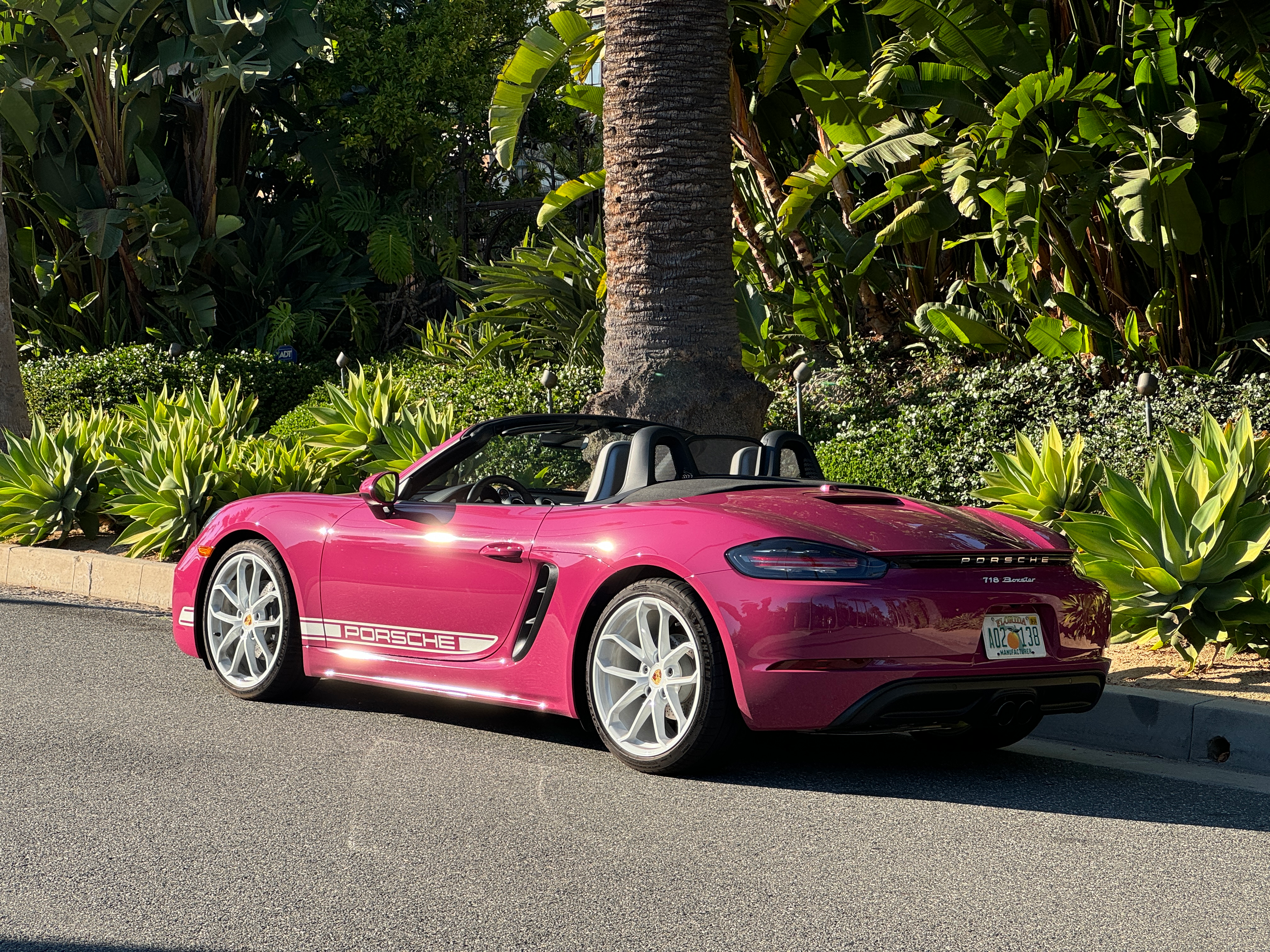 Rear 3/4 view of a pink Porsche 718 Boxster Style Edition