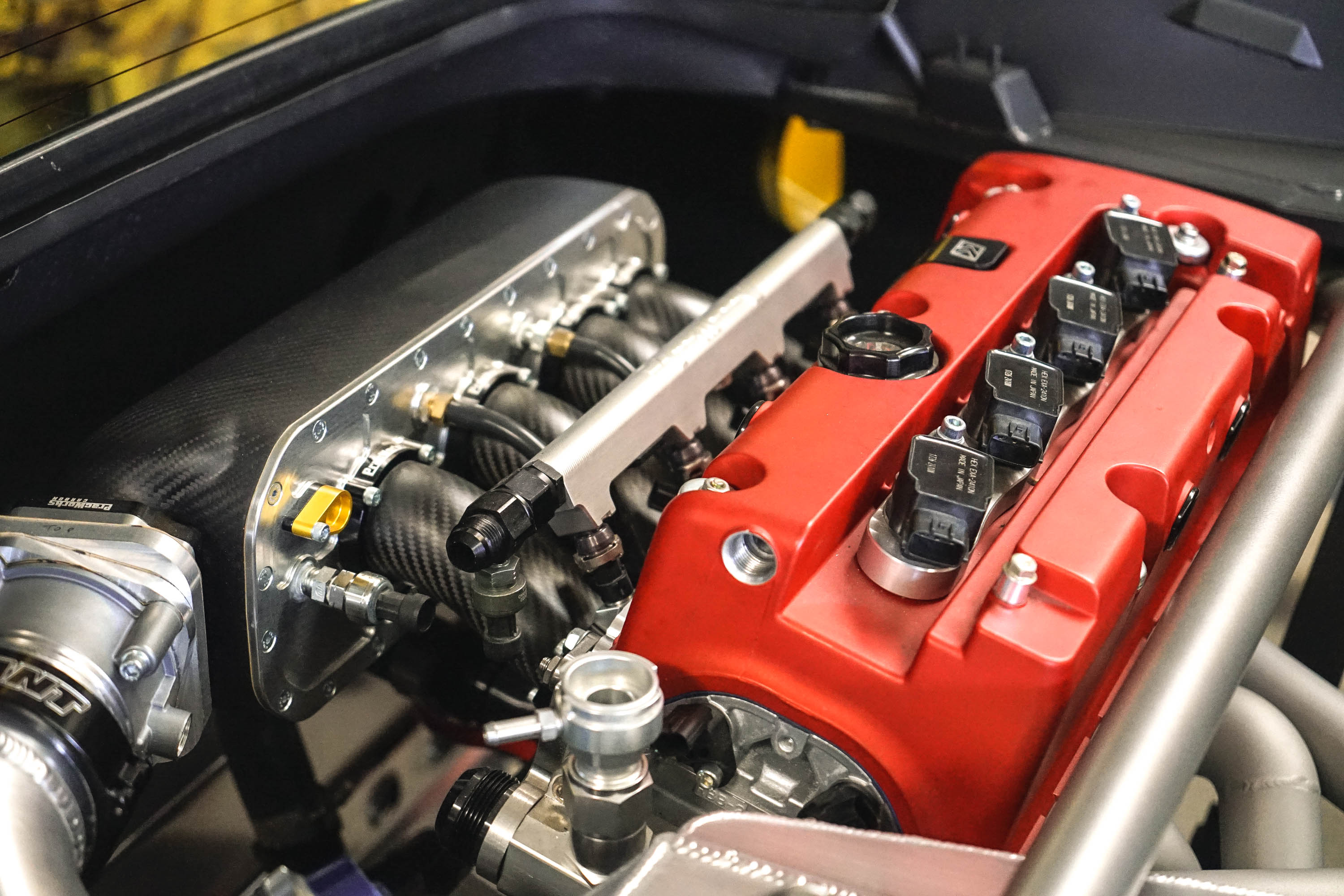 A highly modified Honda K24 engine in a Ferrari engine bay.