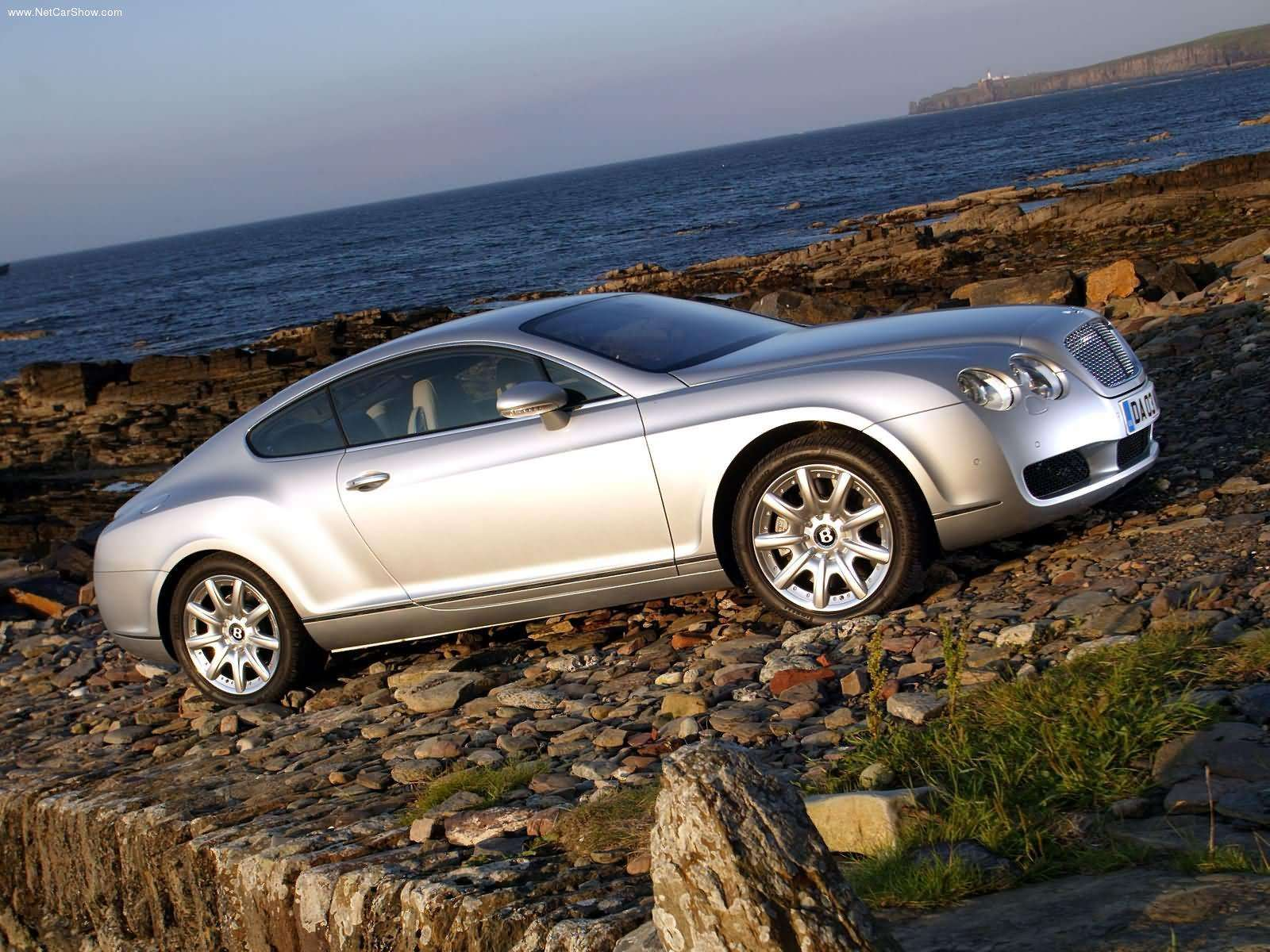 A 2003 Bentley Continental GT is parked by the sea.