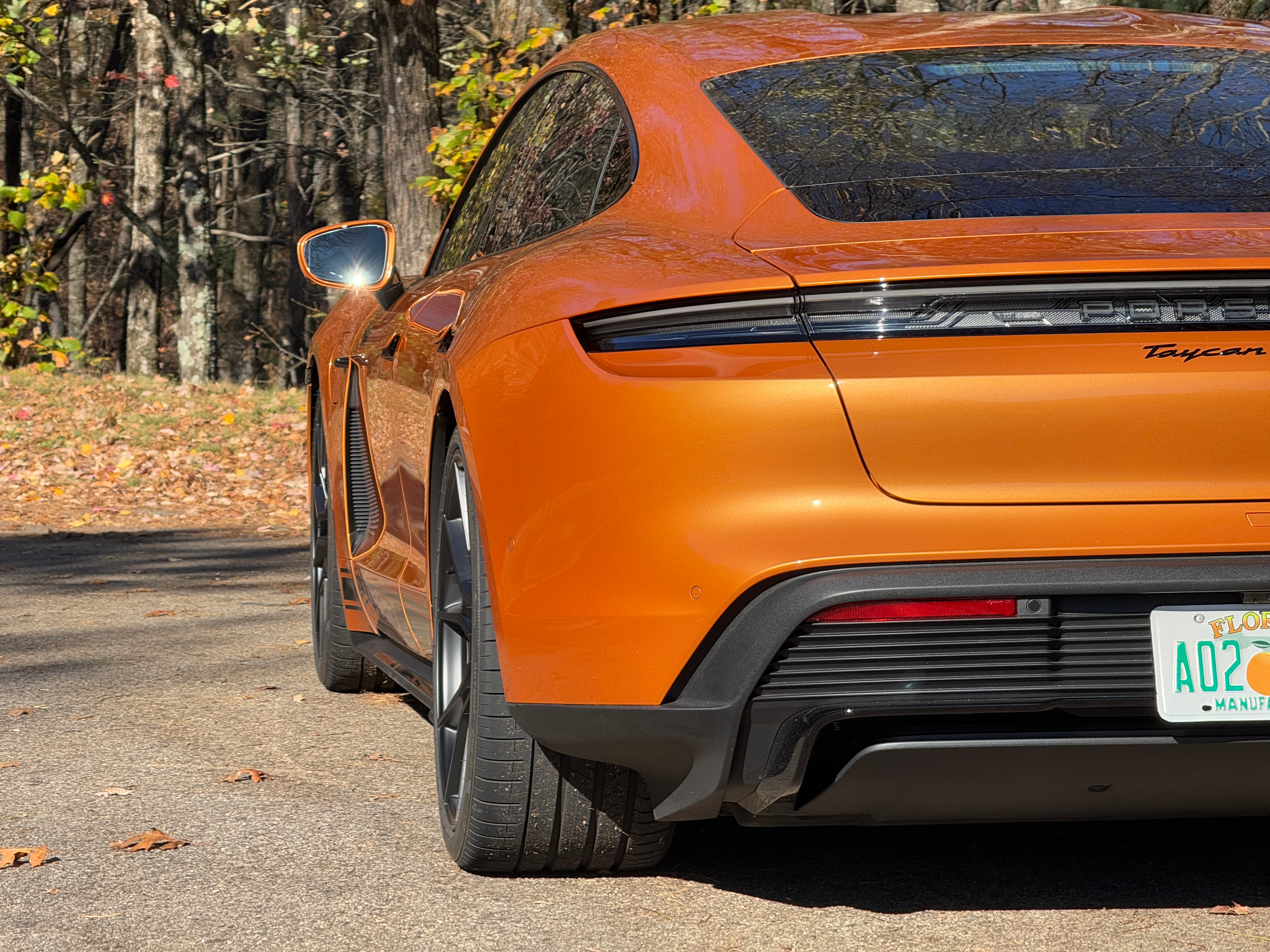 Rear end of a Nordic Gold 2025 Porsche Taycan GTS sedan