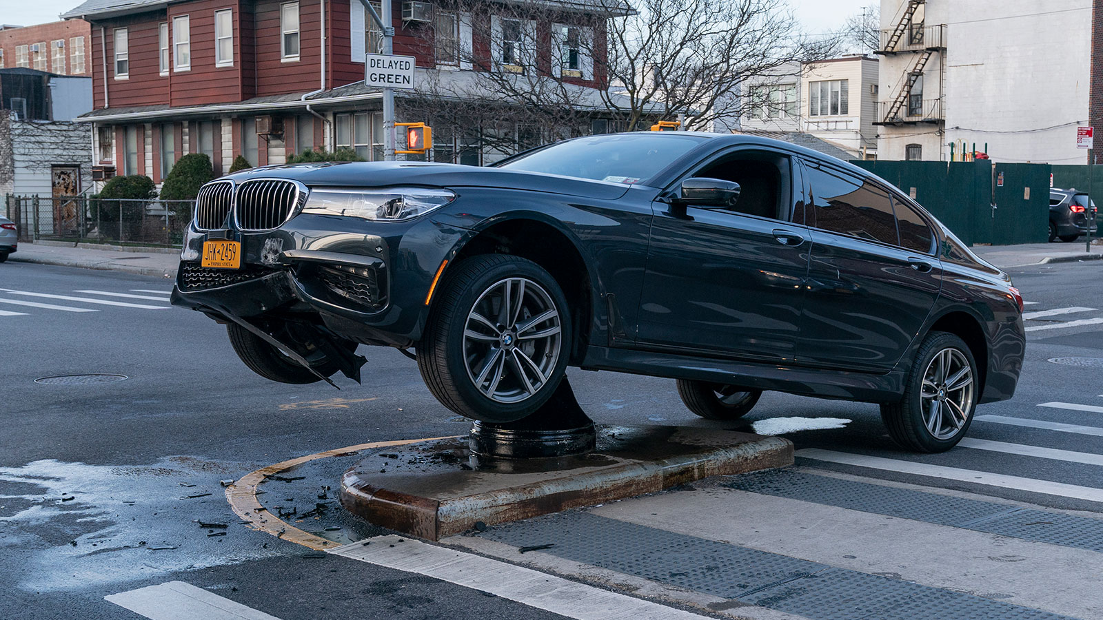 A photo of a BMW crashed into a bollard. 