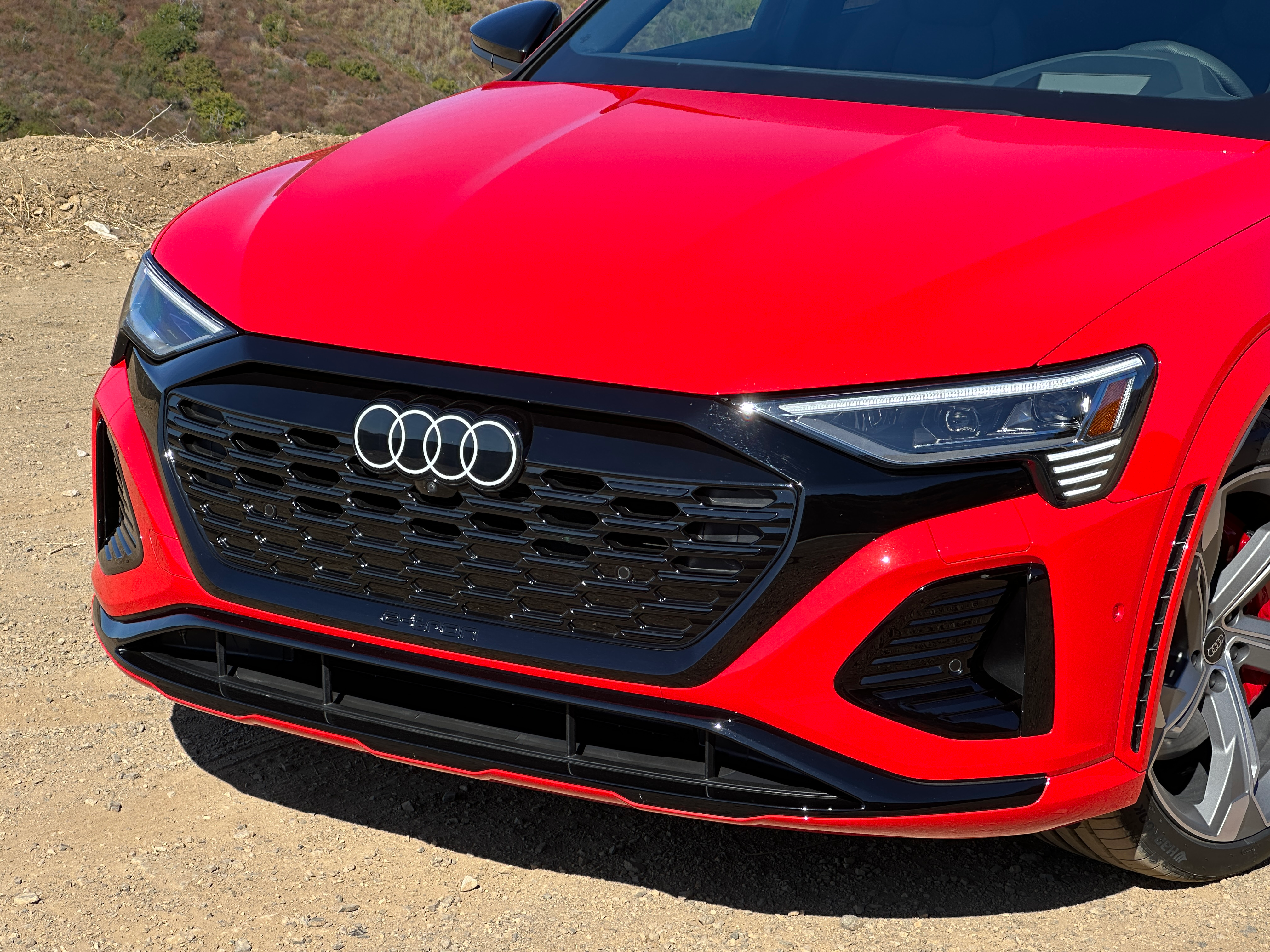 Up-close shot of the front end of a bright red Audi SQ8 E-Tron Sportback