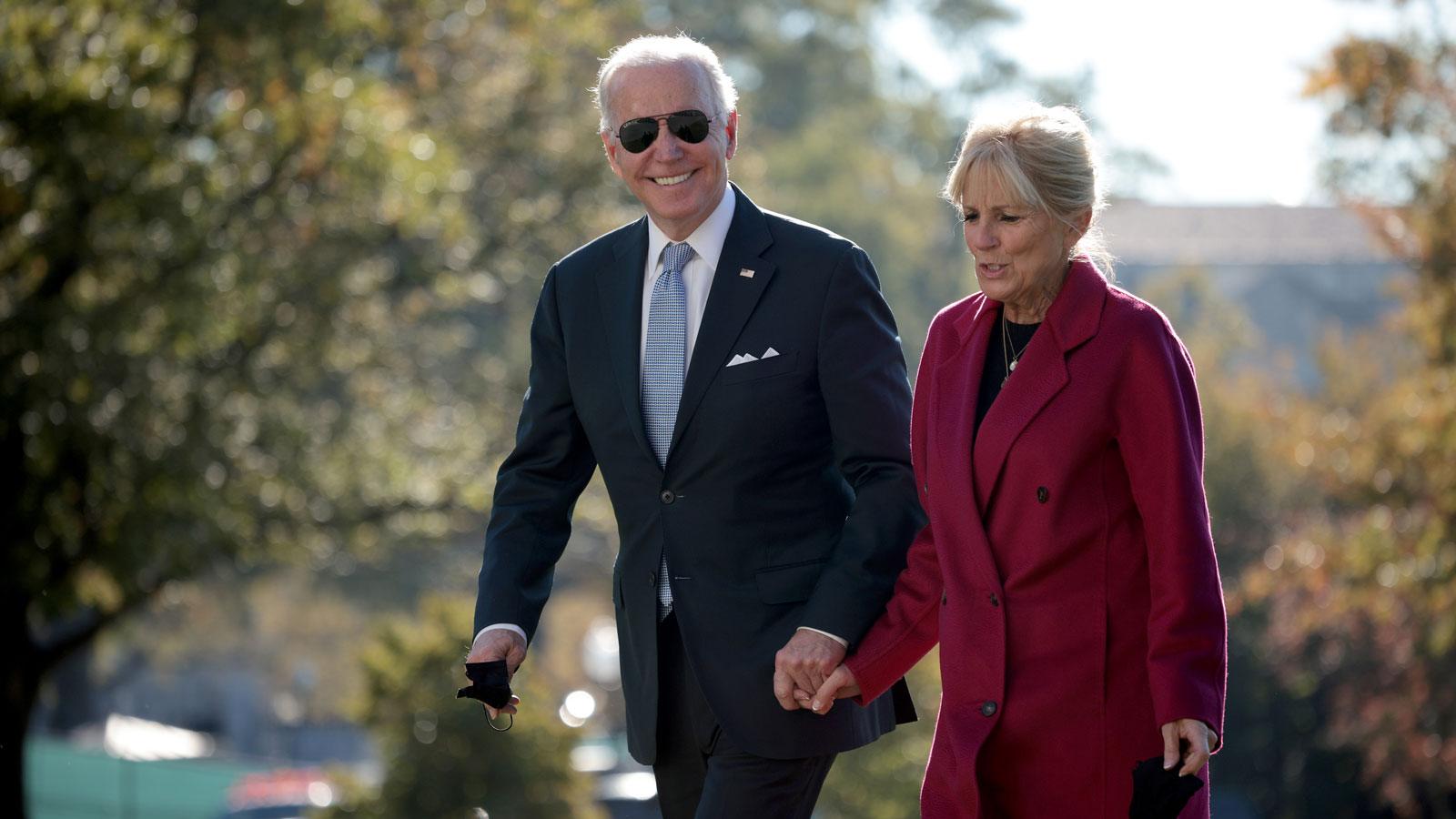 Joe and Jill Biden walking across the White House lawn 