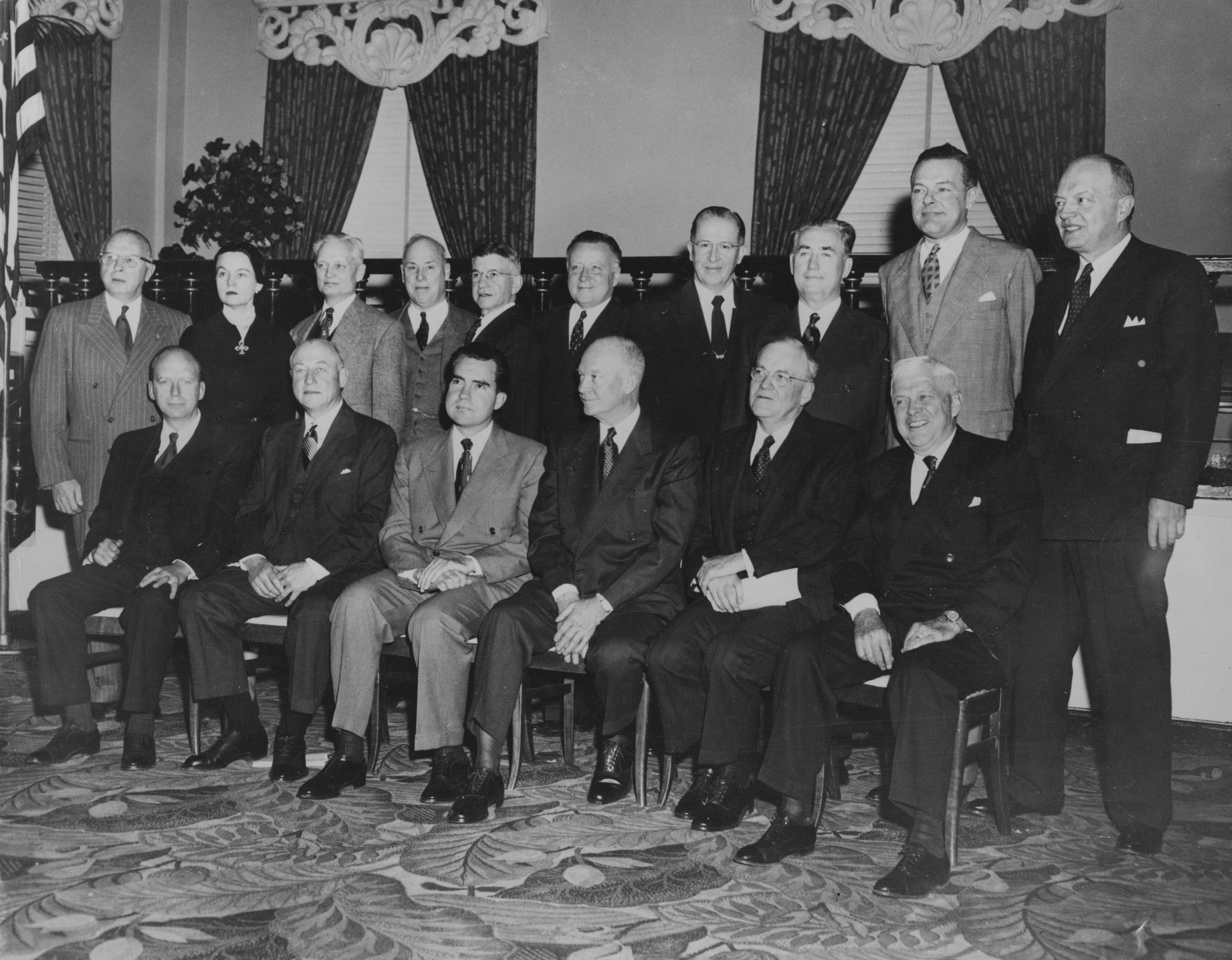 That's President-elect Eisenhower in the middle of his cabinet in 1953. Directly to his right is Nixon, and all the way on his left is Charlie Wilson, sitting closest to camera. He seems chuffed.